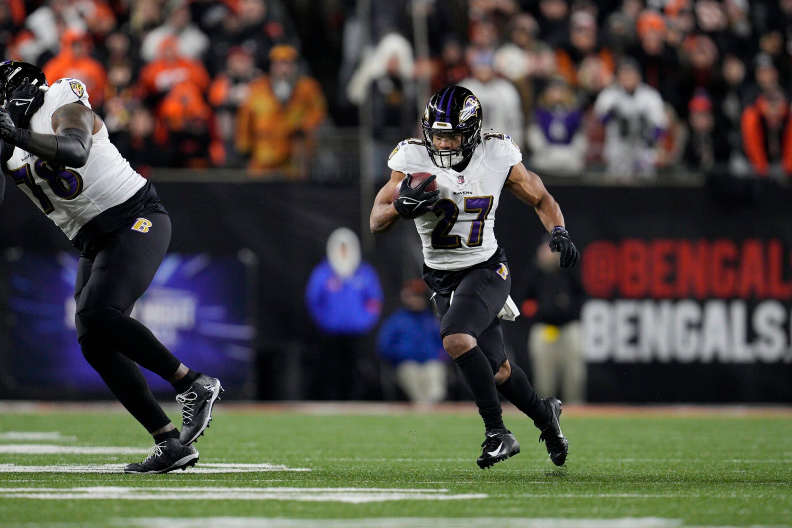 Baltimore Ravens running back J.K. Dobbins runs with the ball in the first half of an NFL wild-card playoff football game against the Cincinnati Bengals in Cincinnati, Sunday, Jan. 15, 2023. (AP Photo/Jeff Dean)