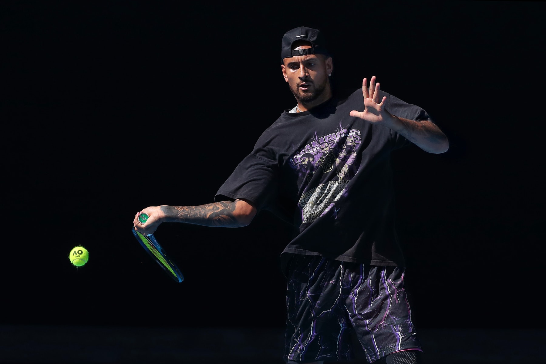 MELBOURNE, AUSTRALIA - JANUARY 14: Nick Kyrgios of Australia plays a forehand during a practice session ahead of the 2023 Australian Open at Melbourne Park on January 13, 2023 in Melbourne, Australia. (Photo by Kelly Defina/Getty Images)