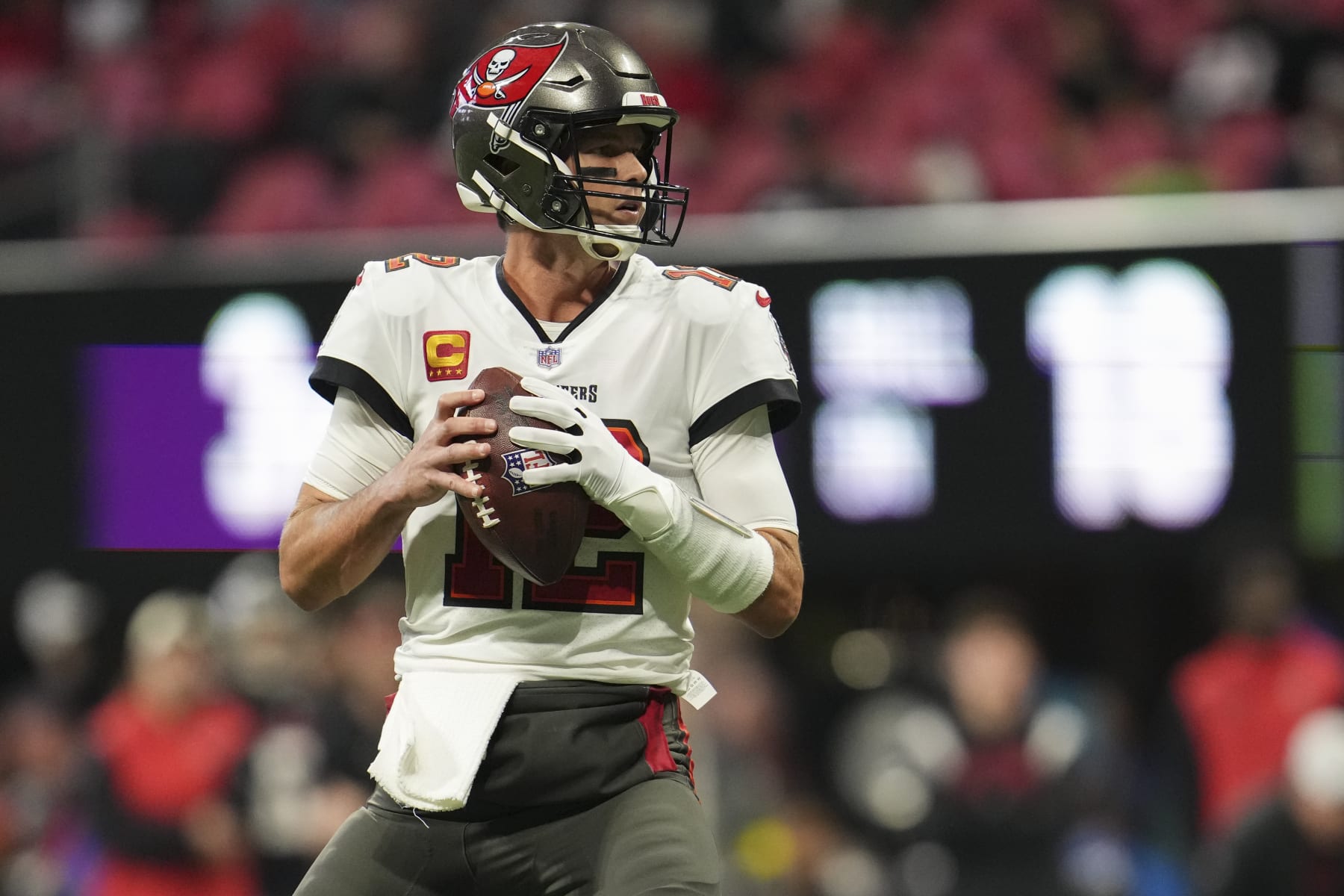 ATLANTA, GA - JANUARY 08: Tom Brady #12 of the Tampa Bay Buccaneers drops back against the Atlanta Falcons at Mercedes-Benz Stadium on January 8, 2023 in Atlanta, Georgia. (Photo by Cooper Neill/Getty Images)