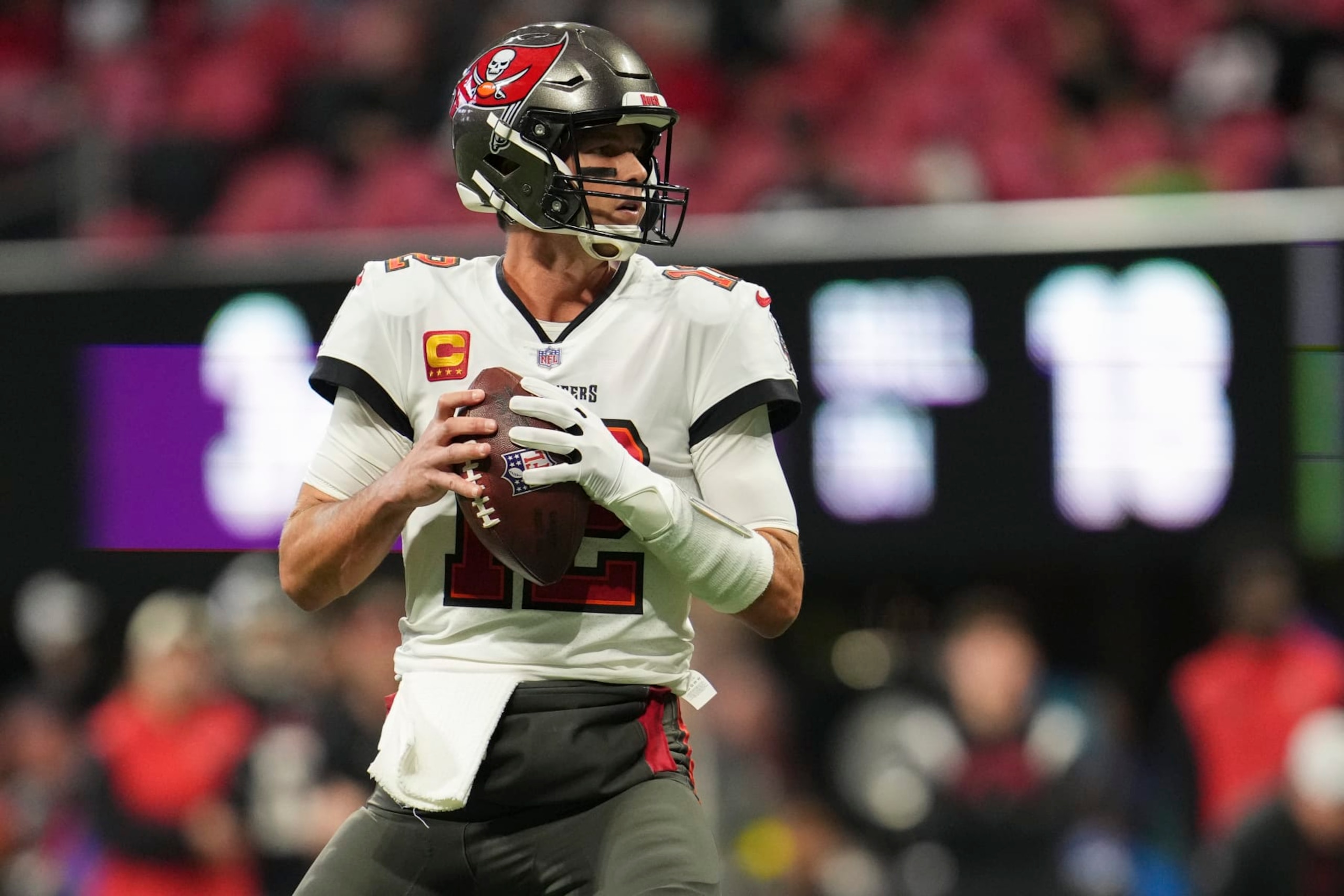 ATLANTA, GA - JANUARY 08: Tom Brady #12 of the Tampa Bay Buccaneers drops back against the Atlanta Falcons at Mercedes-Benz Stadium on January 8, 2023 in Atlanta, Georgia. (Photo by Cooper Neill/Getty Images)
