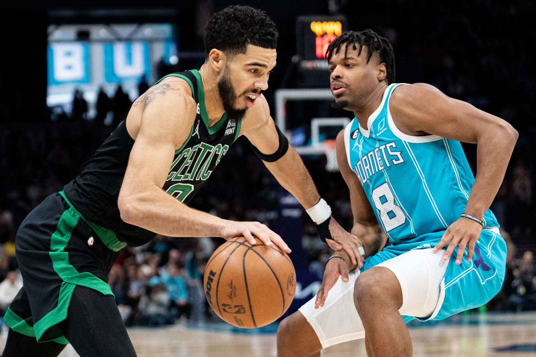 CHARLOTTE, NORTH CAROLINA - JANUARY 16: Jayson Tatum #0 of the Boston Celtics drives to the basket while guarded by Dennis Smith Jr. #8 of the Charlotte Hornets in the first quarter during their game at Spectrum Center on January 16, 2023 in Charlotte, North Carolina. NOTE TO USER: User expressly acknowledges and agrees that, by downloading and or using this photograph, User is consenting to the terms and conditions of the Getty Images License Agreement. (Photo by Jacob Kupferman/Getty Images)