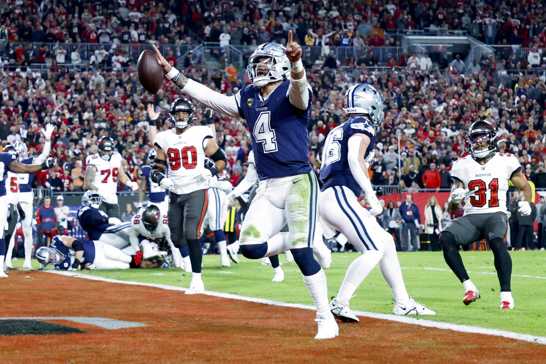 TAMPA, FLORIDA - JANUARY 16: Dak Prescott #4 of the Dallas Cowboys rushes for a touchdown against the Tampa Bay Buccaneers during the second quarter in the NFC Wild Card playoff game at Raymond James Stadium on January 16, 2023 in Tampa, Florida. (Photo by Mike Ehrmann/Getty Images)