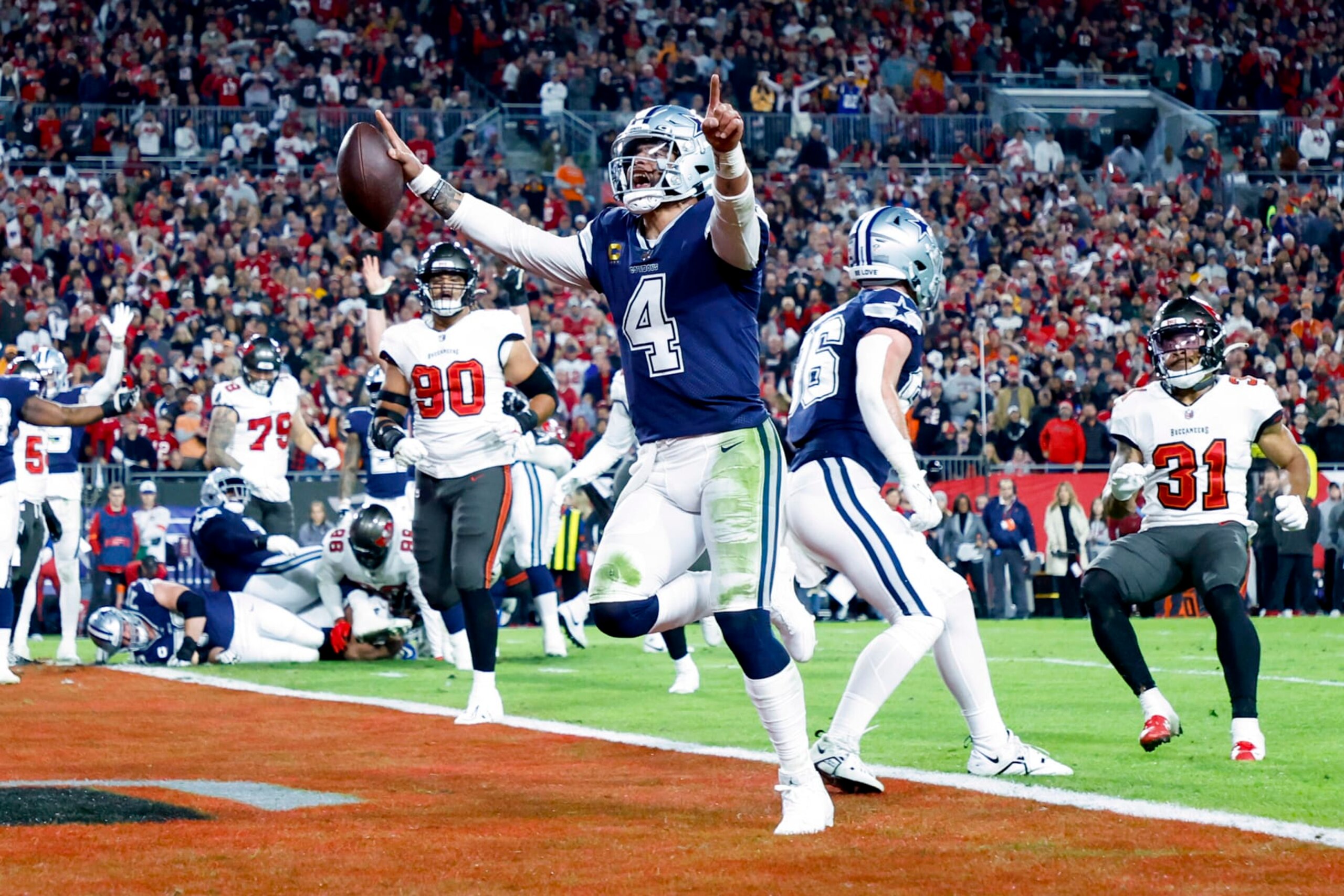 TAMPA, FLORIDA - JANUARY 16: Dak Prescott #4 of the Dallas Cowboys rushes for a touchdown against the Tampa Bay Buccaneers during the second quarter in the NFC Wild Card playoff game at Raymond James Stadium on January 16, 2023 in Tampa, Florida. (Photo by Mike Ehrmann/Getty Images)