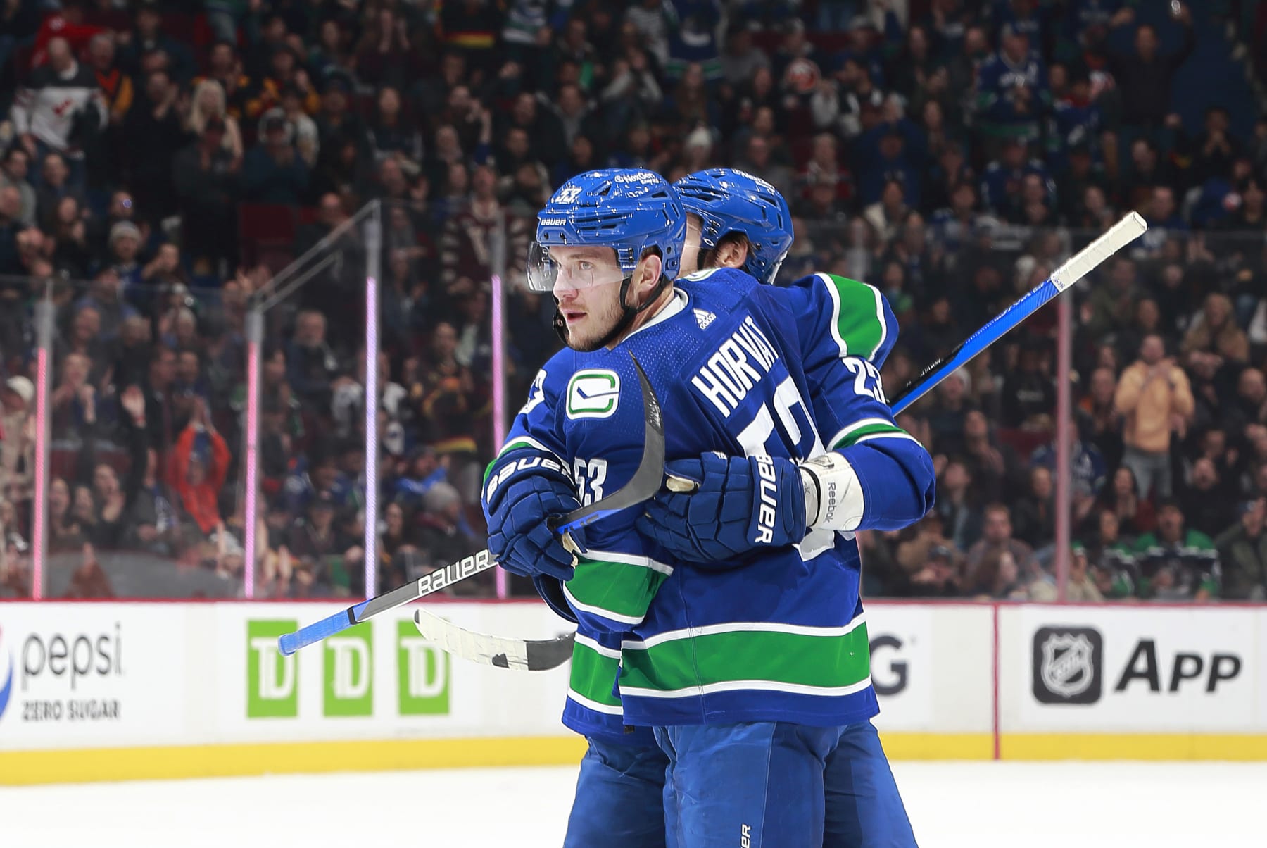 VANCOUVER, CANADA - JANUARY 3: Bo Horvat #53 of the Vancouver Canucks celebrates his goal with Oliver Ekman-Larsson #23 during the first period of their NHL game against the New York Islanders at Rogers Arena January 3, 2023 in Vancouver, British Columbia, Canada.  (Photo by Jeff Vinnick/NHLI via Getty Images)