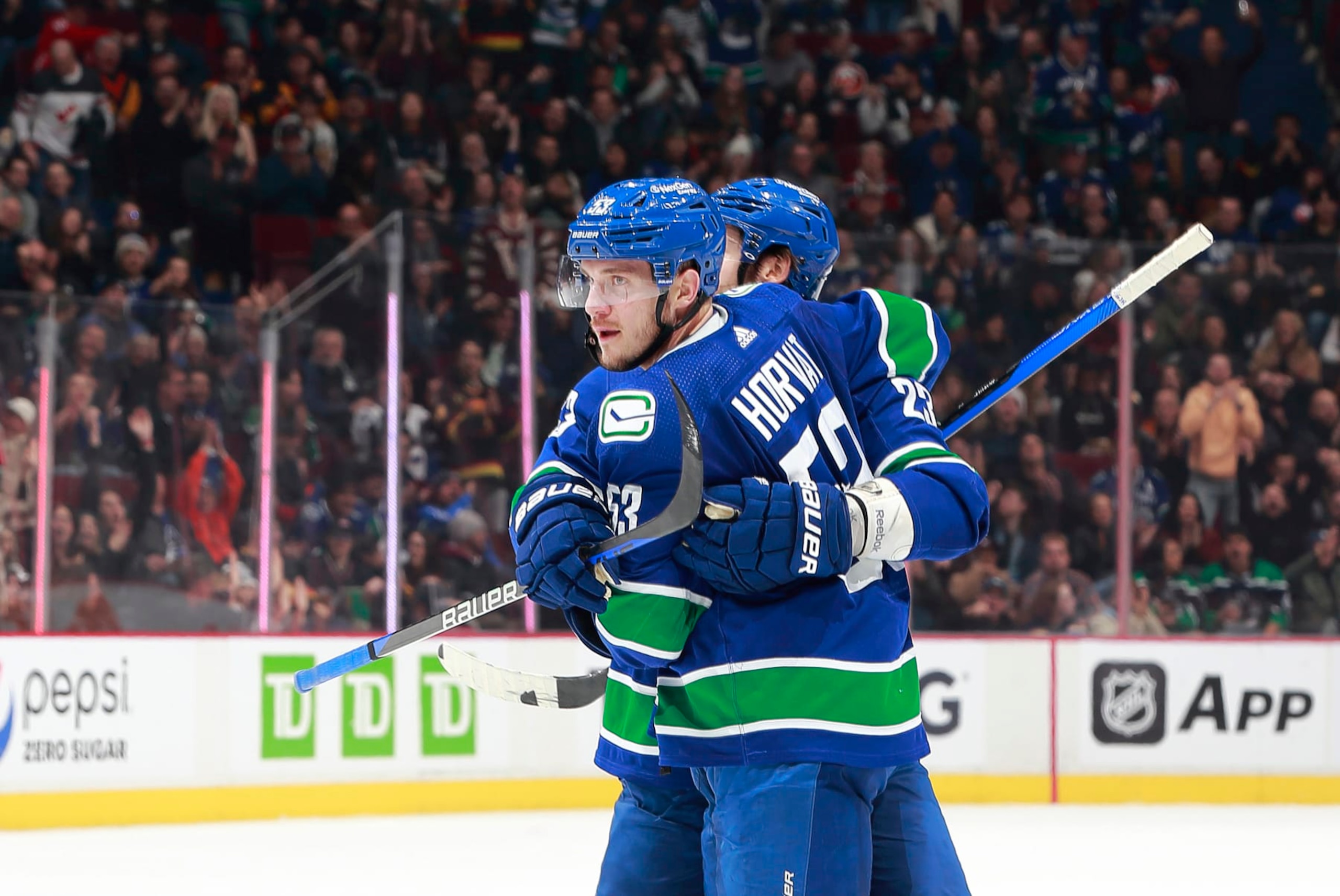 VANCOUVER, CANADA - JANUARY 3: Bo Horvat #53 of the Vancouver Canucks celebrates his goal with Oliver Ekman-Larsson #23 during the first period of their NHL game against the New York Islanders at Rogers Arena January 3, 2023 in Vancouver, British Columbia, Canada.  (Photo by Jeff Vinnick/NHLI via Getty Images)
