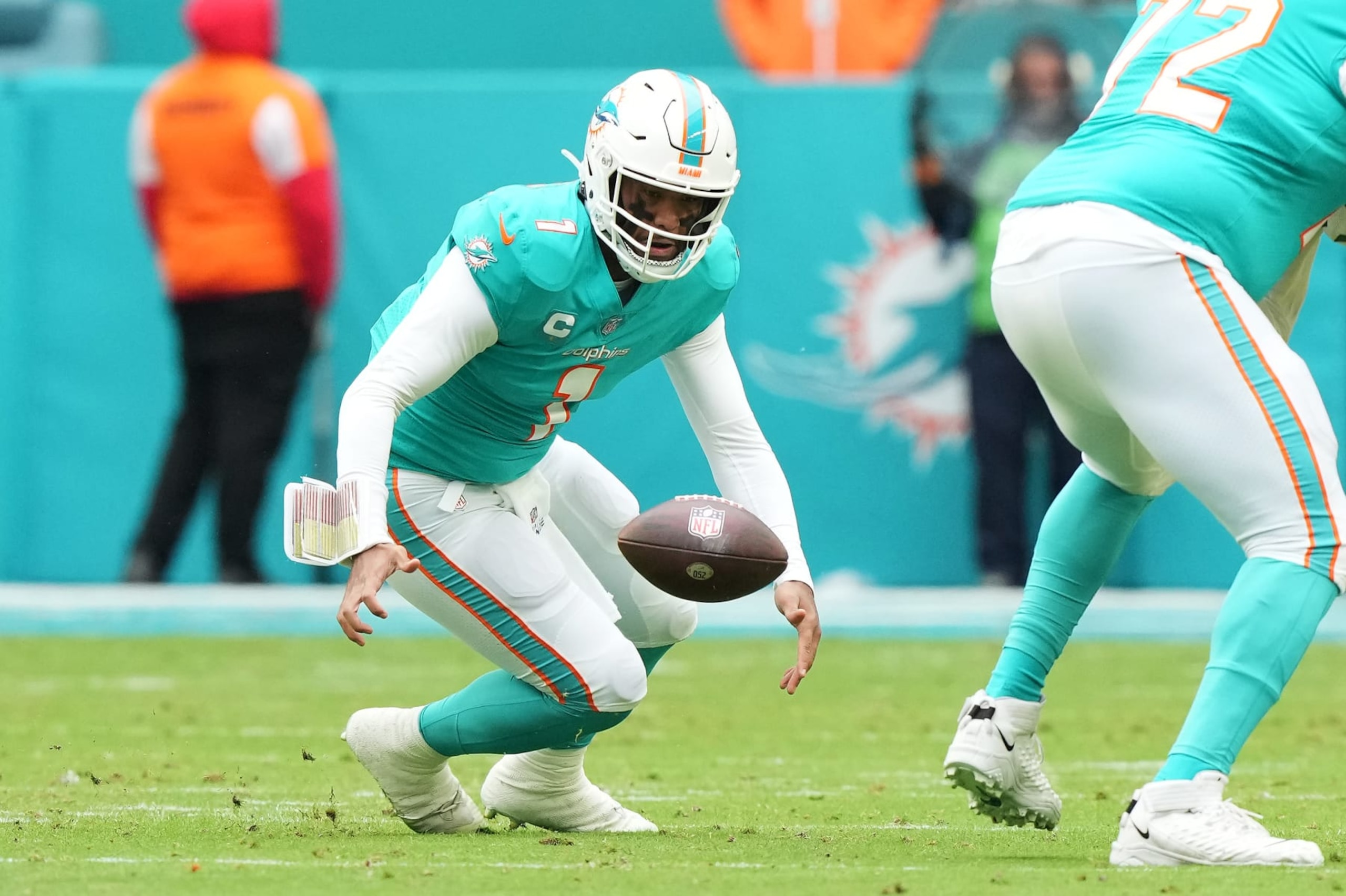 MIAMI GARDENS, FLORIDA - DECEMBER 25: Tua Tagovailoa #1 of the Miami Dolphins recovers a fumble during the first quarter of the game against the Green Bay Packers at Hard Rock Stadium on December 25, 2022 in Miami Gardens, Florida. (Photo by Eric Espada/Getty Images)