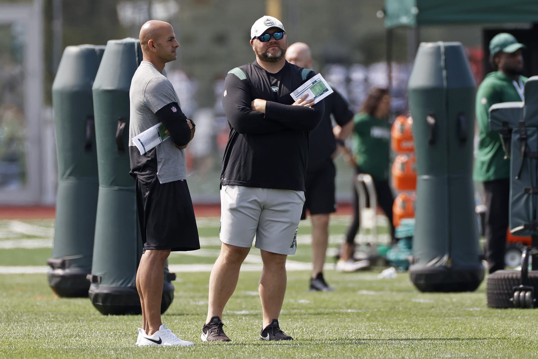 New York Jets general manager Joe Douglas, center, talks with head coach Robert Saleh during NFL football practice Wednesday, July 28, 2021, in Florham Park, N.J. (AP Photo/Adam Hunger)