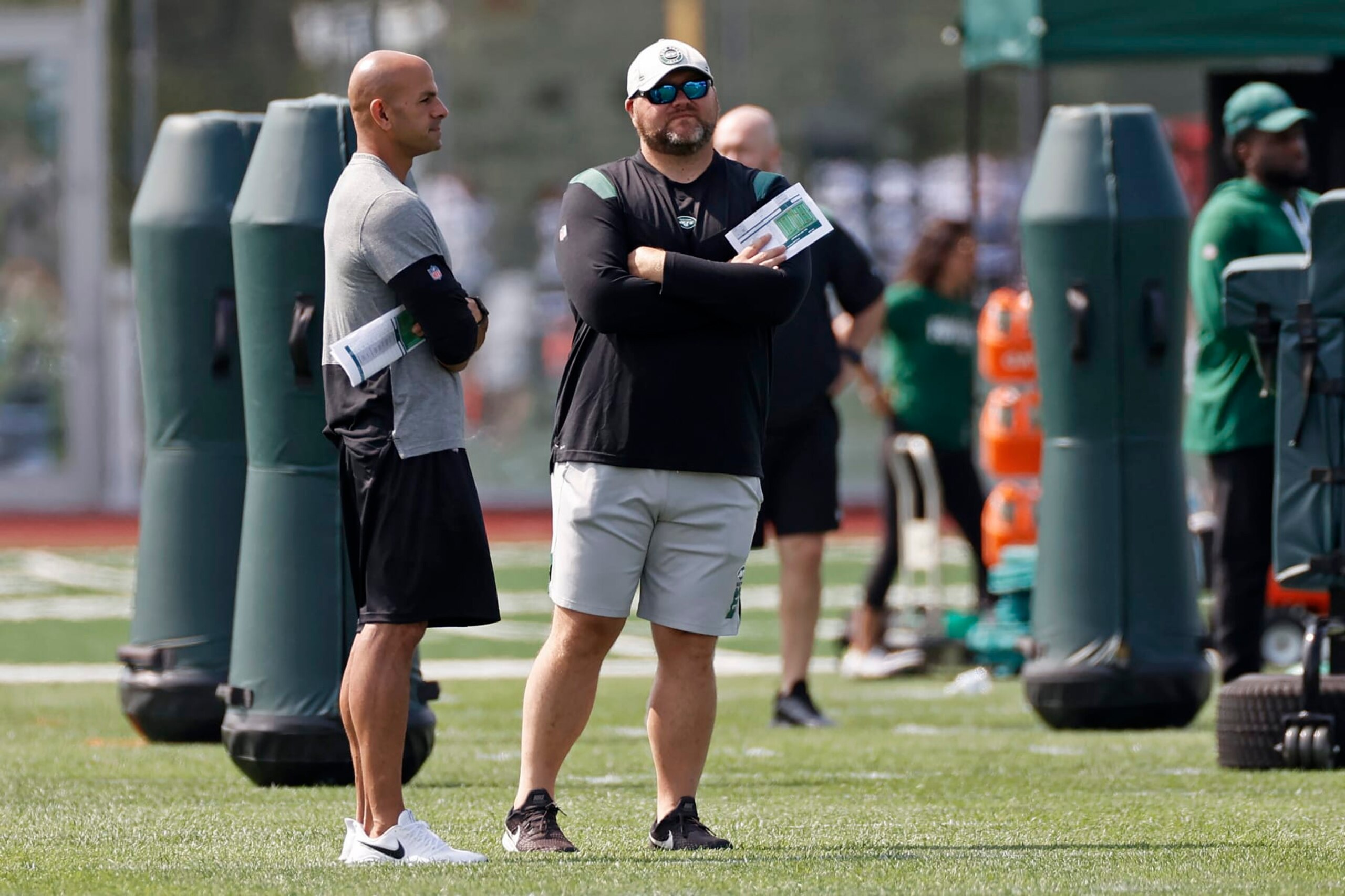 New York Jets general manager Joe Douglas, center, talks with head coach Robert Saleh during NFL football practice Wednesday, July 28, 2021, in Florham Park, N.J. (AP Photo/Adam Hunger)