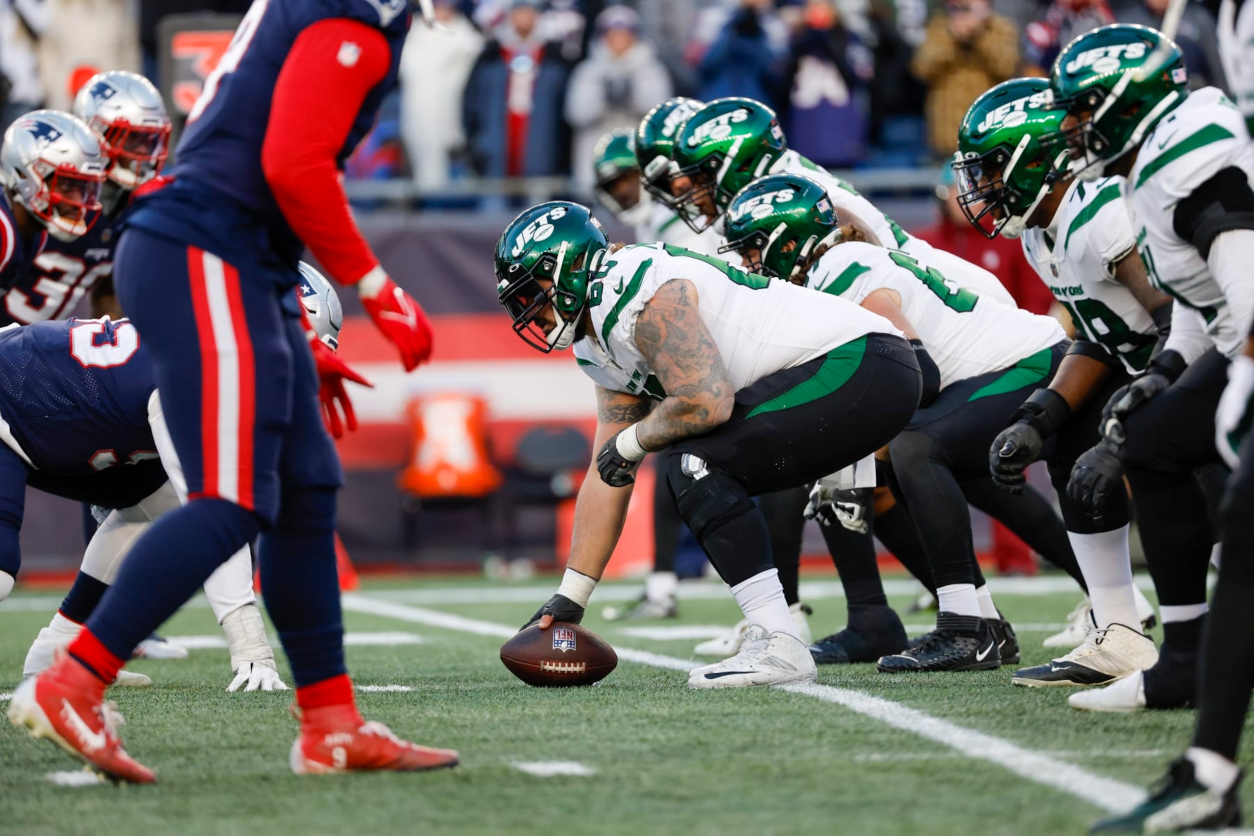 New York Jets center Connor McGovern (60) prepares to hike the ball at the line of scrimmage during the second half of an NFL football game against the New England Patriots, Sunday, Nov. 20, 2022, in Foxborough, Mass. (AP Photo/Greg M. Cooper)
