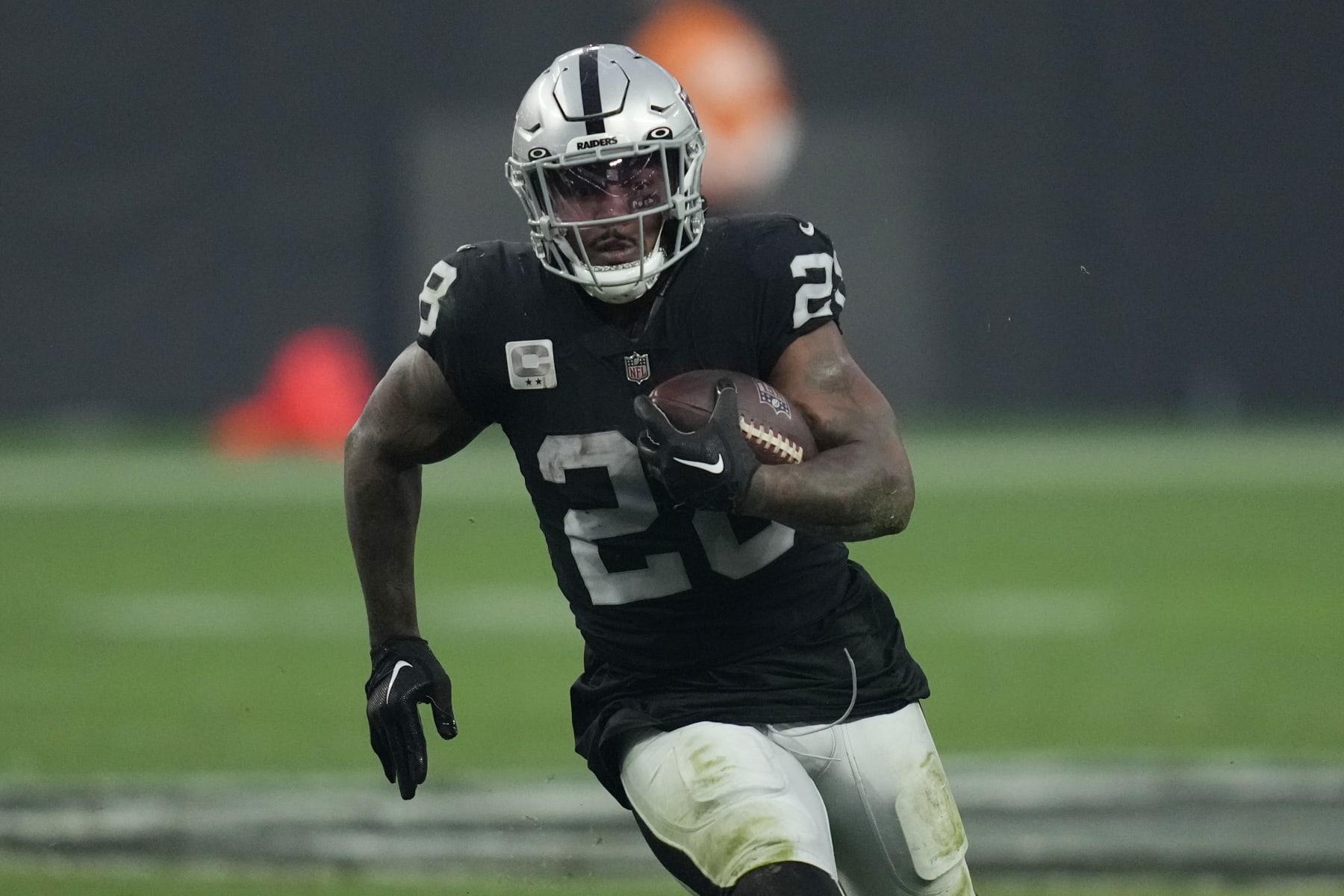 Las Vegas Raiders running back Josh Jacobs (28) runs against the Kansas City Chiefs during the second half of an NFL football game, Wednesday, Jan. 11, 2023, in Las Vegas. (AP Photo/John Locher)