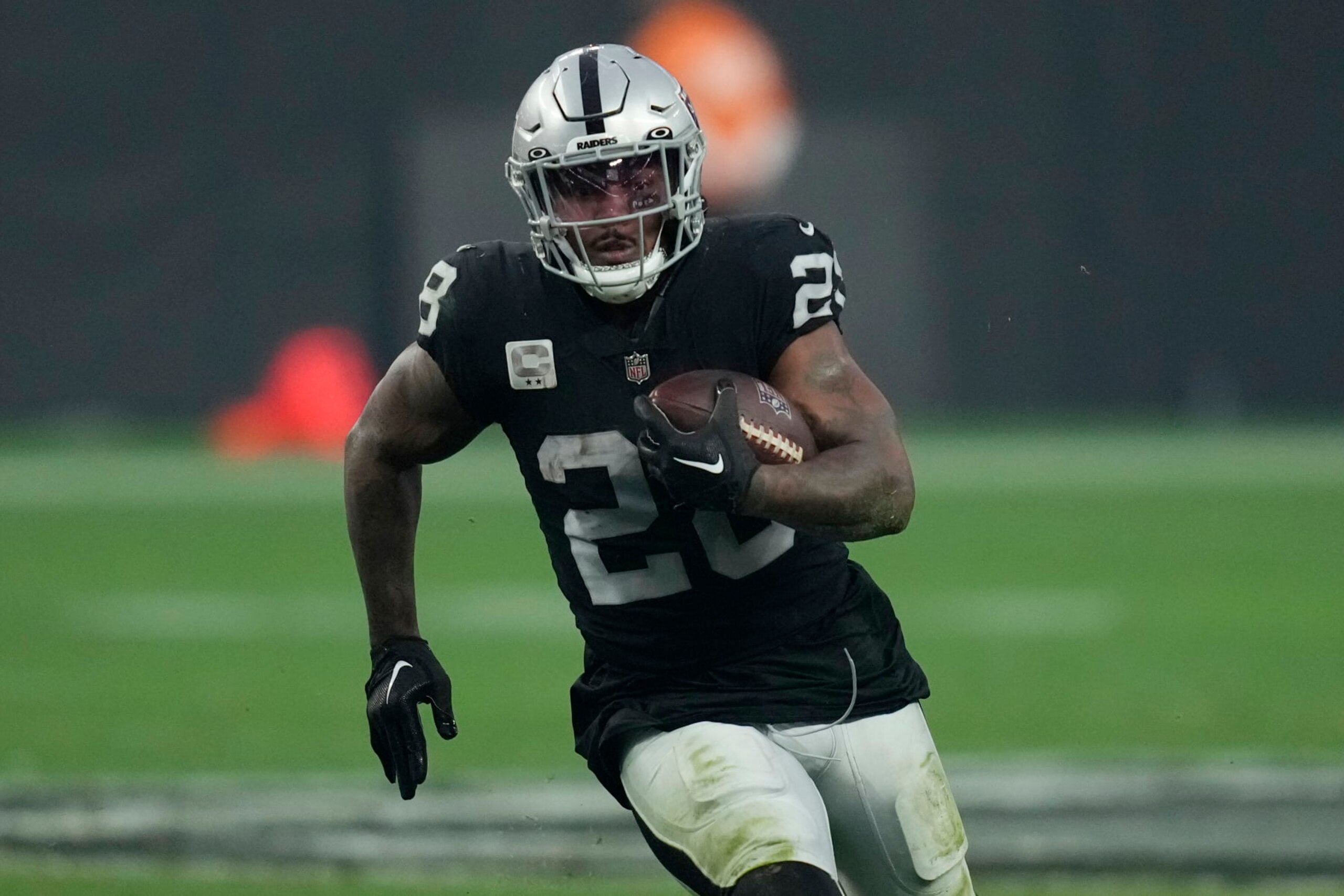 Las Vegas Raiders running back Josh Jacobs (28) runs against the Kansas City Chiefs during the second half of an NFL football game, Wednesday, Jan. 11, 2023, in Las Vegas. (AP Photo/John Locher)