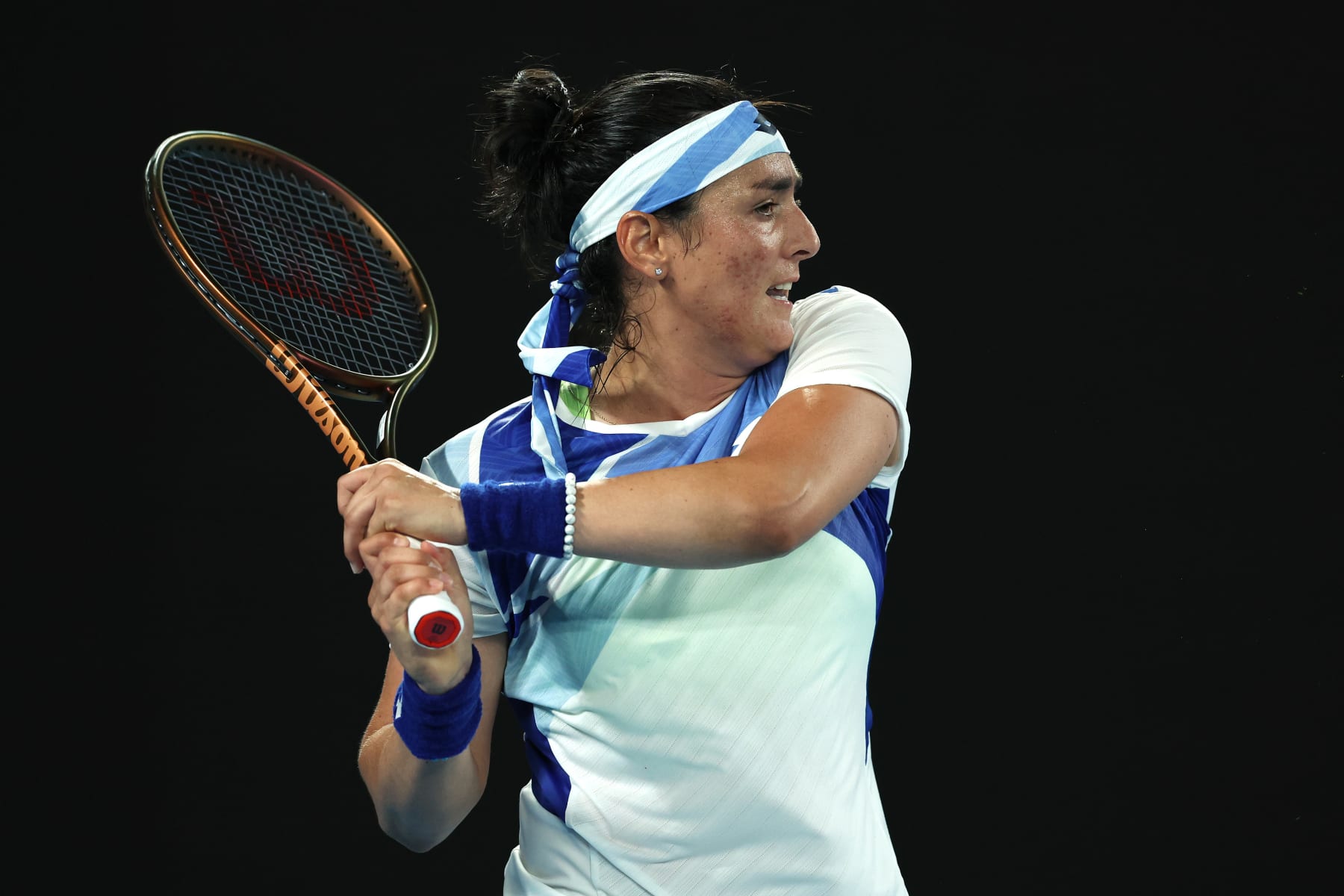 MELBOURNE, AUSTRALIA - JANUARY 17: Ons Jabeur of Tunisia plays a backhand in their round one singles match against Tamara Zidansek of Slovenia during day two of the 2023 Australian Open at Melbourne Park on January 17, 2023 in Melbourne, Australia. (Photo by Clive Brunskill/Getty Images)
