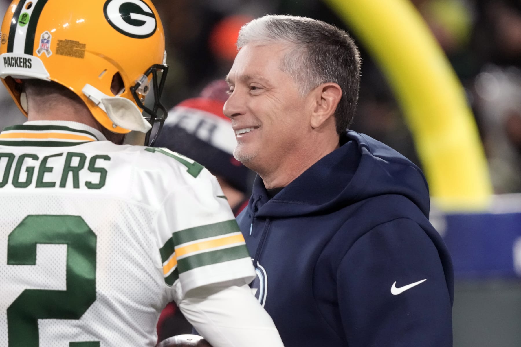 FILE - Green Bay Packers quarterback Aaron Rodgers talks with Tennessee Titans senior advisor Jim Schwartz before an NFL football game Thursday, Nov. 17, 2022, in Green Bay, Wis. Schwartz is interviewing Wednesday, Jan. 11, 2023, with Cleveland for their defensive coordinator vacancy created when coach Kevin Stefanski fired Joe Woods following a season of defensive collapses by the Browns. The 56-year-old Schwartz has been a senior advisor with the Tennessee Titans for the past two seasons. (AP Photo/Morry Gash, File)