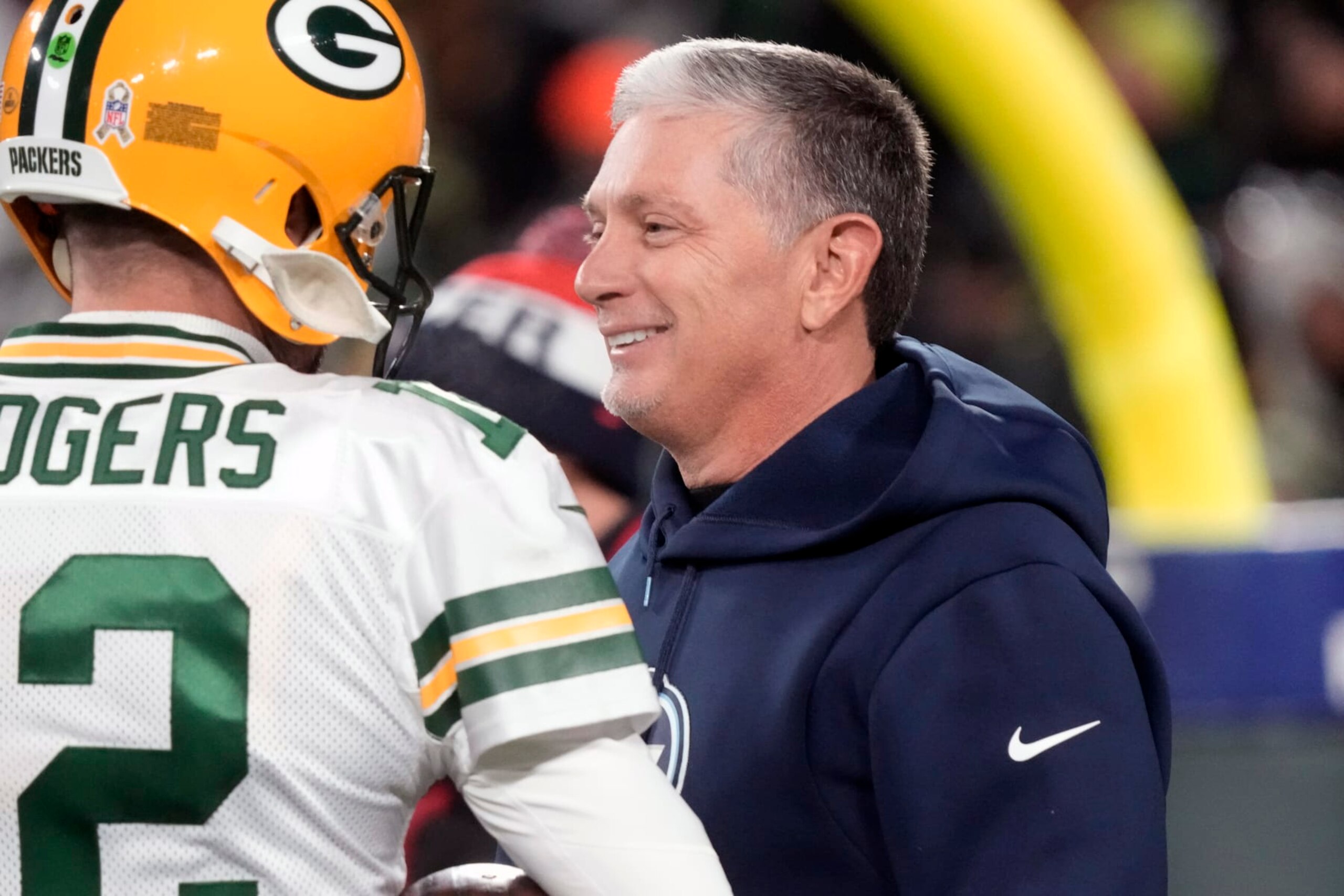 FILE - Green Bay Packers quarterback Aaron Rodgers talks with Tennessee Titans senior advisor Jim Schwartz before an NFL football game Thursday, Nov. 17, 2022, in Green Bay, Wis. Schwartz is interviewing Wednesday, Jan. 11, 2023, with Cleveland for their defensive coordinator vacancy created when coach Kevin Stefanski fired Joe Woods following a season of defensive collapses by the Browns. The 56-year-old Schwartz has been a senior advisor with the Tennessee Titans for the past two seasons. (AP Photo/Morry Gash, File)