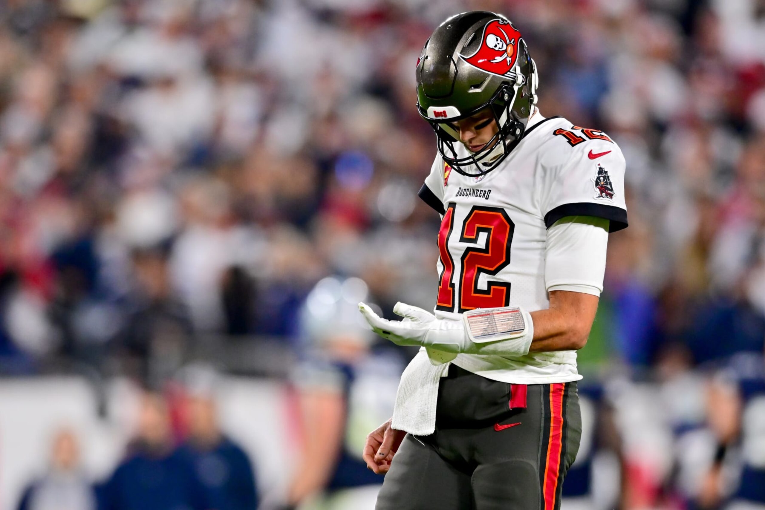 TAMPA, FLORIDA - JANUARY 16: Tom Brady #12 of the Tampa Bay Buccaneers looks on after a fumble against the Dallas Cowboys during the third quarter in the NFC Wild Card playoff game at Raymond James Stadium on January 16, 2023 in Tampa, Florida. (Photo by Julio Aguilar/Getty Images)
