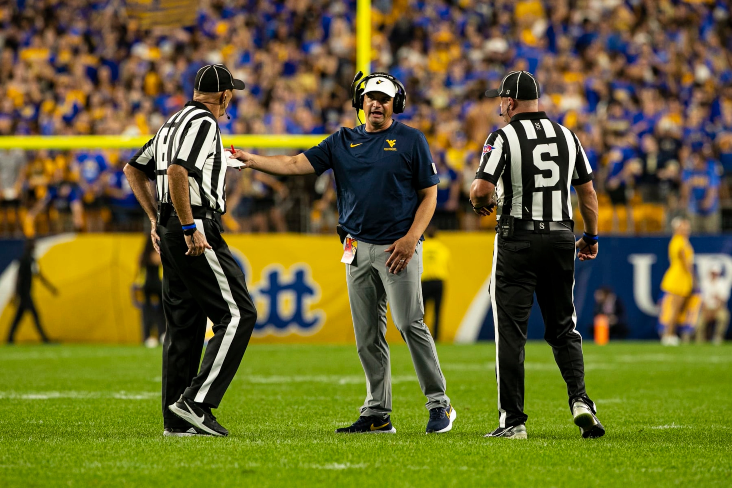 PITTSBURGH, PA - SEPTEMBER 01: West Virginia Mountaineers head coach Neal Brown talks to the referees during the college football game between the West Virginia Mountaineers and the Pittsburgh Panthers on September 01, 2022 at Acrisure Stadium in Pittsburgh, PA. (Photo by Mark Alberti/Icon Sportswire via Getty Images)