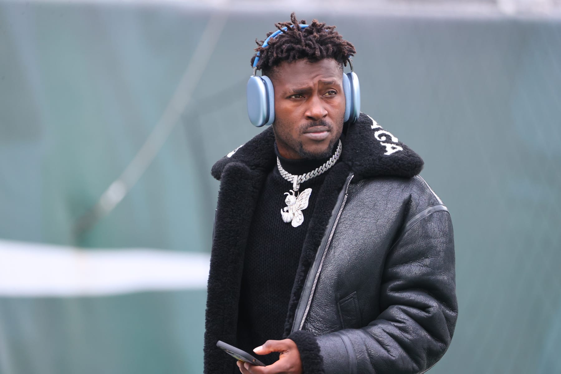EAST RUTHERFORD, NJ - JANUARY 02:  Tampa Bay Buccaneers wide receiver Antonio Brown (81) on the field in a Balenciaga jacket and a diamond Bee necklace prior to the National Football League game between the New York Jets and the Tampa Bay Buccaneers on January 2, 2022 at MetLife Stadium in East Rutherford, NJ.   (Photo by Rich Graessle/Icon Sportswire via Getty Images)
