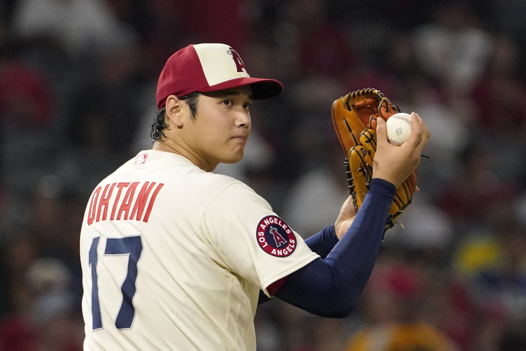 Los Angeles Angels starting pitcher Shohei Ohtani looks toward first base before throwing a pitch during the sixth inning of a baseball game against the Oakland Athletics Thursday, Sept. 29, 2022, in Anaheim, Calif. (AP Photo/Mark J. Terrill)