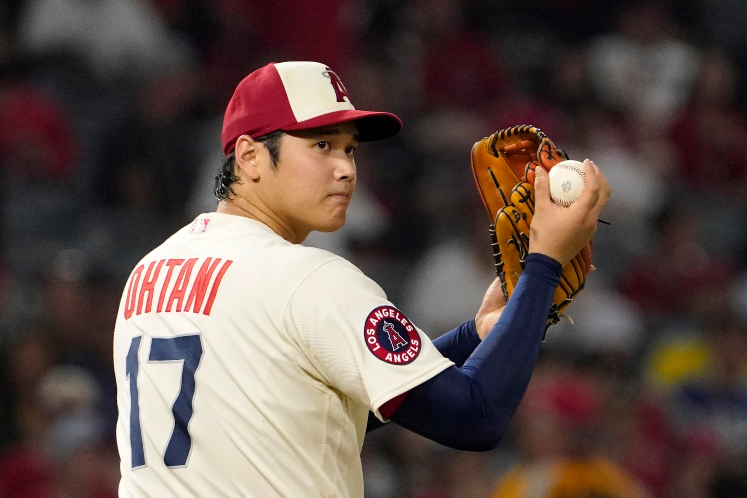 Los Angeles Angels starting pitcher Shohei Ohtani looks toward first base before throwing a pitch during the sixth inning of a baseball game against the Oakland Athletics Thursday, Sept. 29, 2022, in Anaheim, Calif. (AP Photo/Mark J. Terrill)