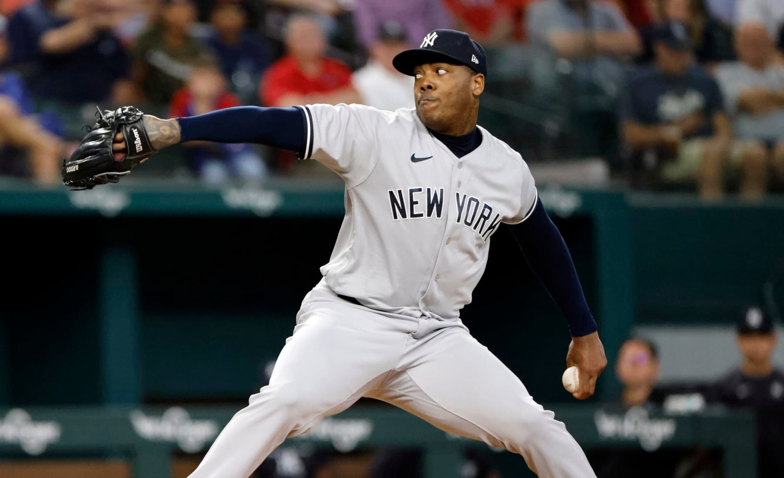 ARLINGTON, TX - OCTOBER 4: Aroldis Chapman #54 of the New York Yankees pitches against the Texas Rangers during the seventh inning in game one of a double header at Globe Life Field on October 4, 2022 in Arlington, Texas. (Photo by Ron Jenkins/Getty Images)
