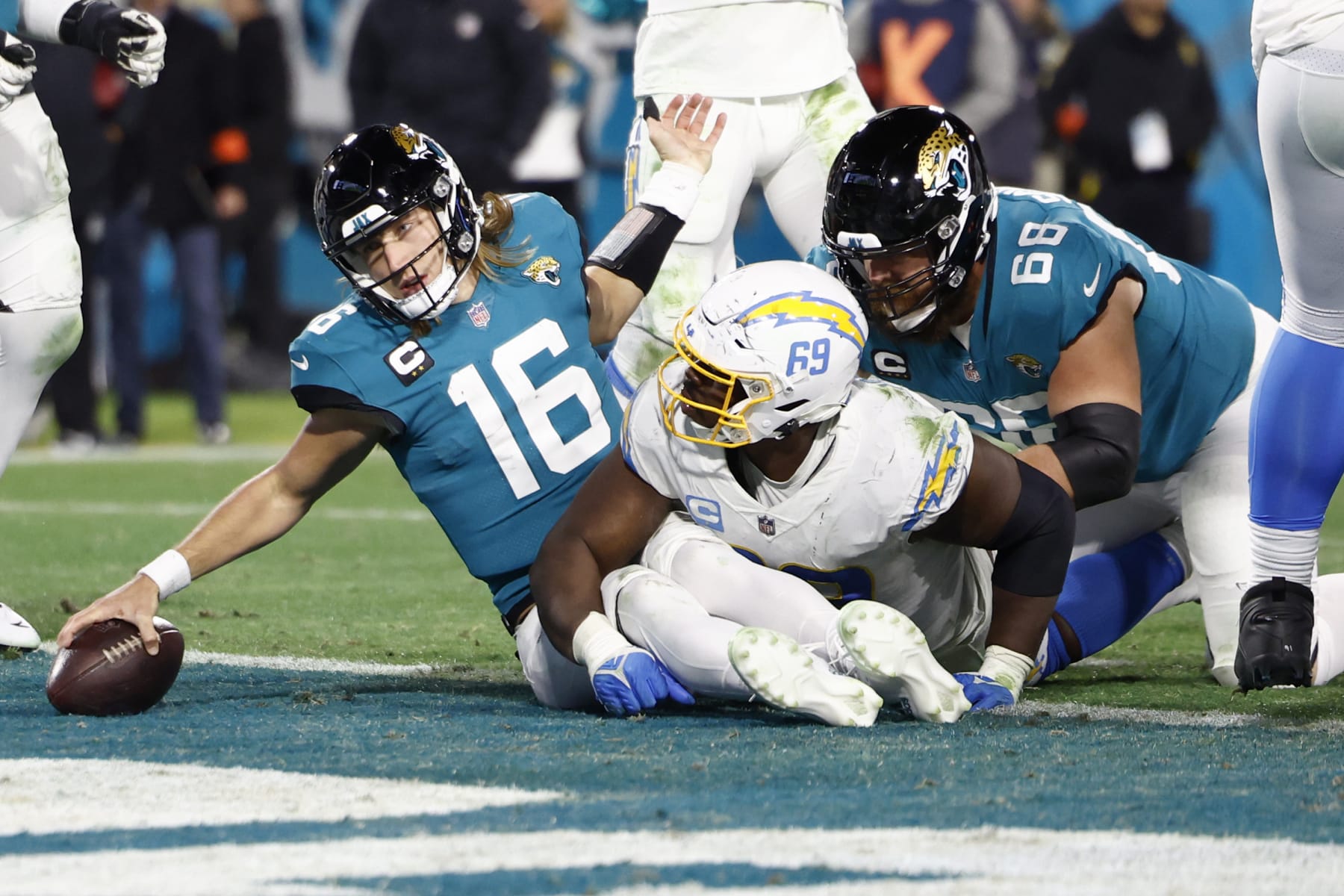 JACKSONVILLE, FLORIDA - JANUARY 14: Trevor Lawrence #16 of the Jacksonville Jaguars dives for a two point conversion against the Los Angeles Chargers during the second half of the game in the AFC Wild Card playoff game at TIAA Bank Field on January 14, 2023 in Jacksonville, Florida. (Photo by Douglas P. DeFelice/Getty Images)