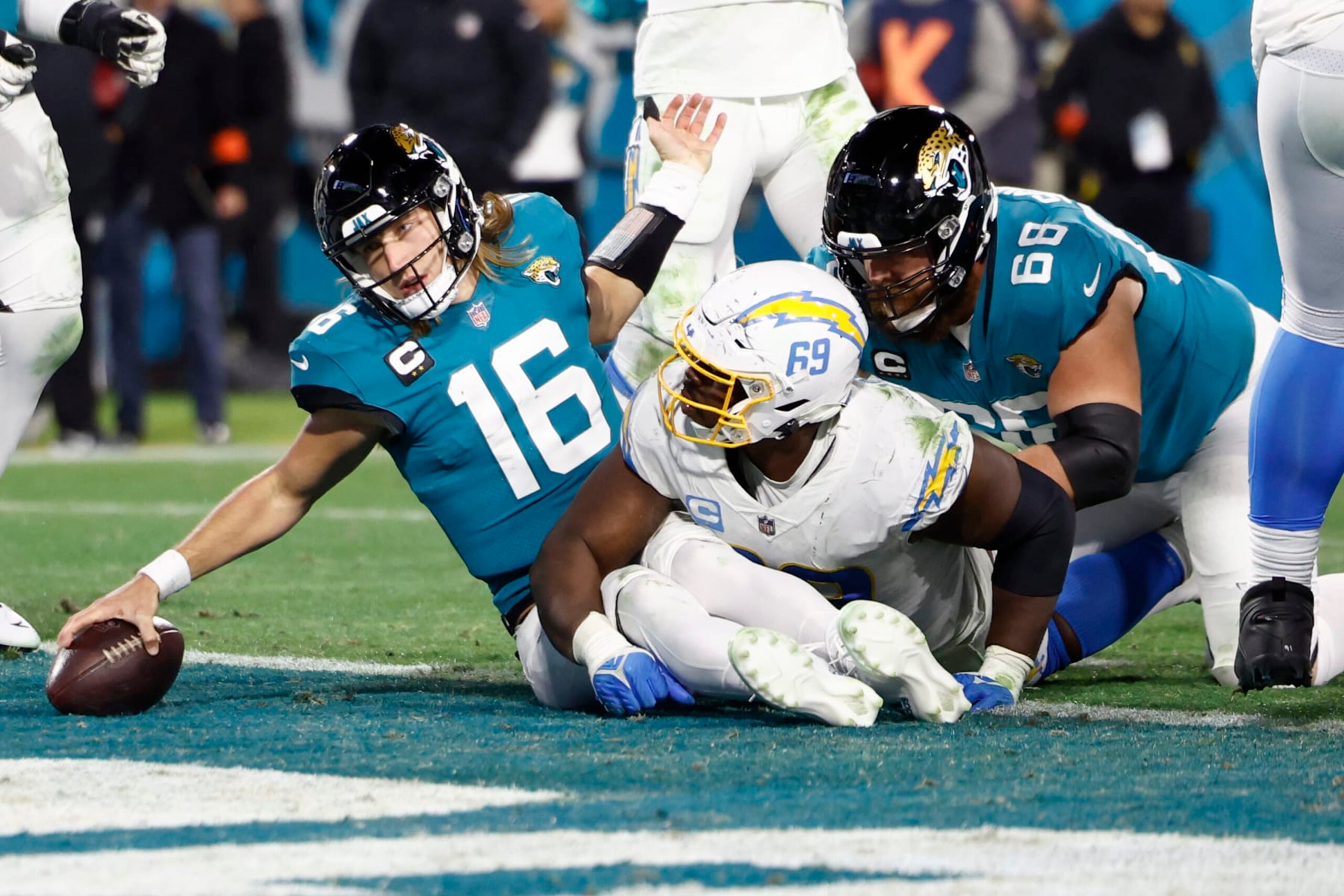 JACKSONVILLE, FLORIDA - JANUARY 14: Trevor Lawrence #16 of the Jacksonville Jaguars dives for a two point conversion against the Los Angeles Chargers during the second half of the game in the AFC Wild Card playoff game at TIAA Bank Field on January 14, 2023 in Jacksonville, Florida. (Photo by Douglas P. DeFelice/Getty Images)