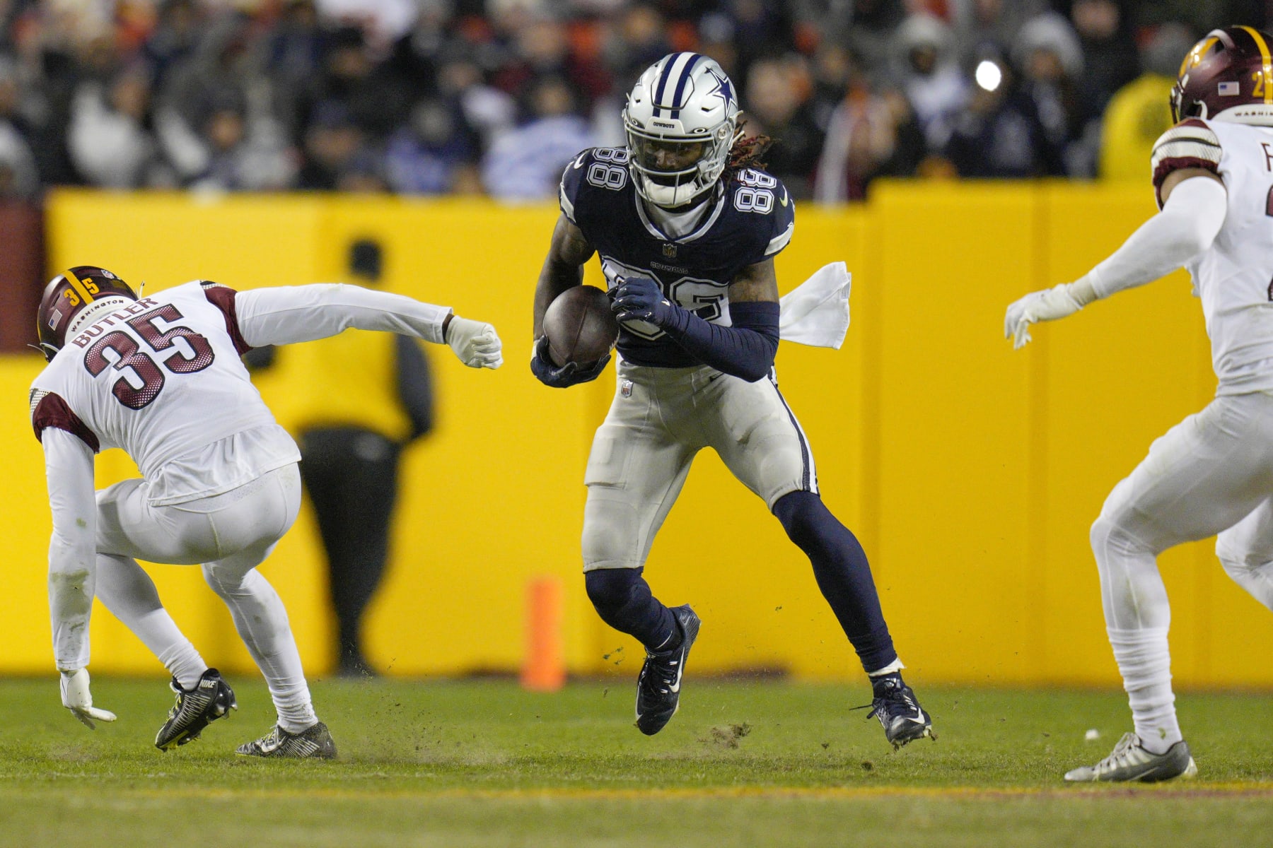 LANDOVER, MARYLAND - JANUARY 08: CeeDee Lamb #88 of the Dallas Cowboys runs with the ball as Percy Butler #35 of the Washington Commanders defends during the second half at FedExField on January 08, 2023 in Landover, Maryland. (Photo by Jess Rapfogel/Getty Images)