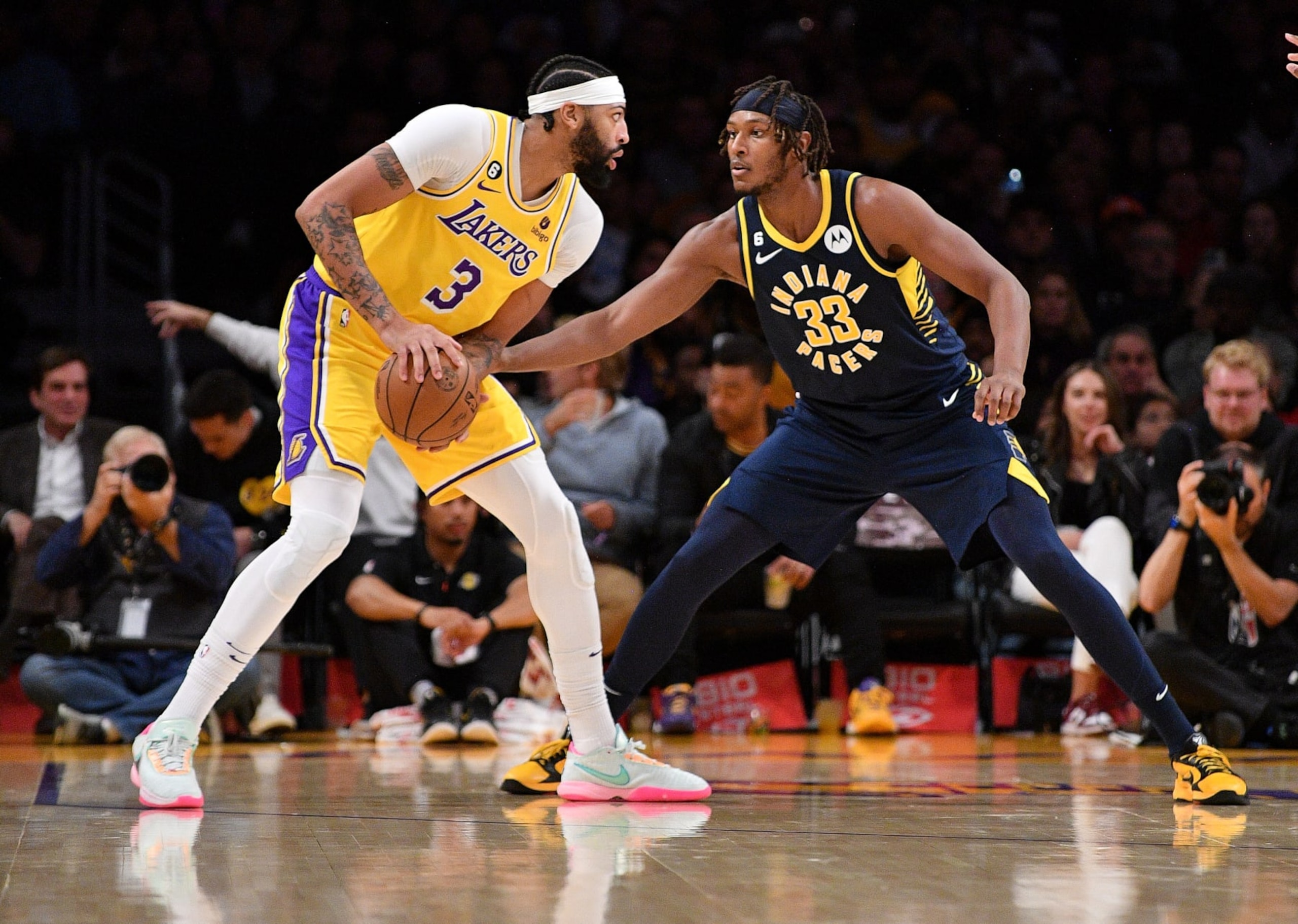 LOS ANGELES, CALIFORNIA - NOVEMBER 28: Anthony Davis #3 of the Los Angeles Lakers holds the ball while being defended by Myles Turner #33 of the Indiana Pacers during the first half of the gameat Crypto.com Arena on November 28, 2022 in Los Angeles, California. NOTE TO USER: User expressly acknowledges and agrees that, by downloading and or using this photograph, User is consenting to the terms and conditions of the Getty Images License Agreement. (Photo by Allen Berezovsky/Getty Images)