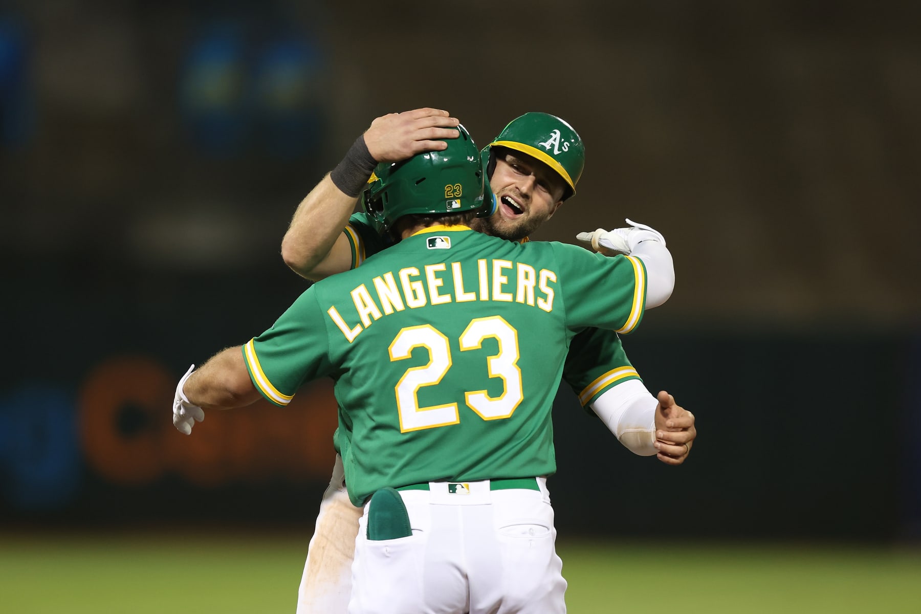 OAKLAND, CALIFORNIA - OCTOBER 04: Shea Langeliers #23 of the Oakland Athletics celebrates with Seth Brown #15 after drawing a walk with bases loaded in the bottom of the tenth inning to win the game against the Los Angeles Angels at RingCentral Coliseum on October 04, 2022 in Oakland, California. (Photo by Lachlan Cunningham/Getty Images)