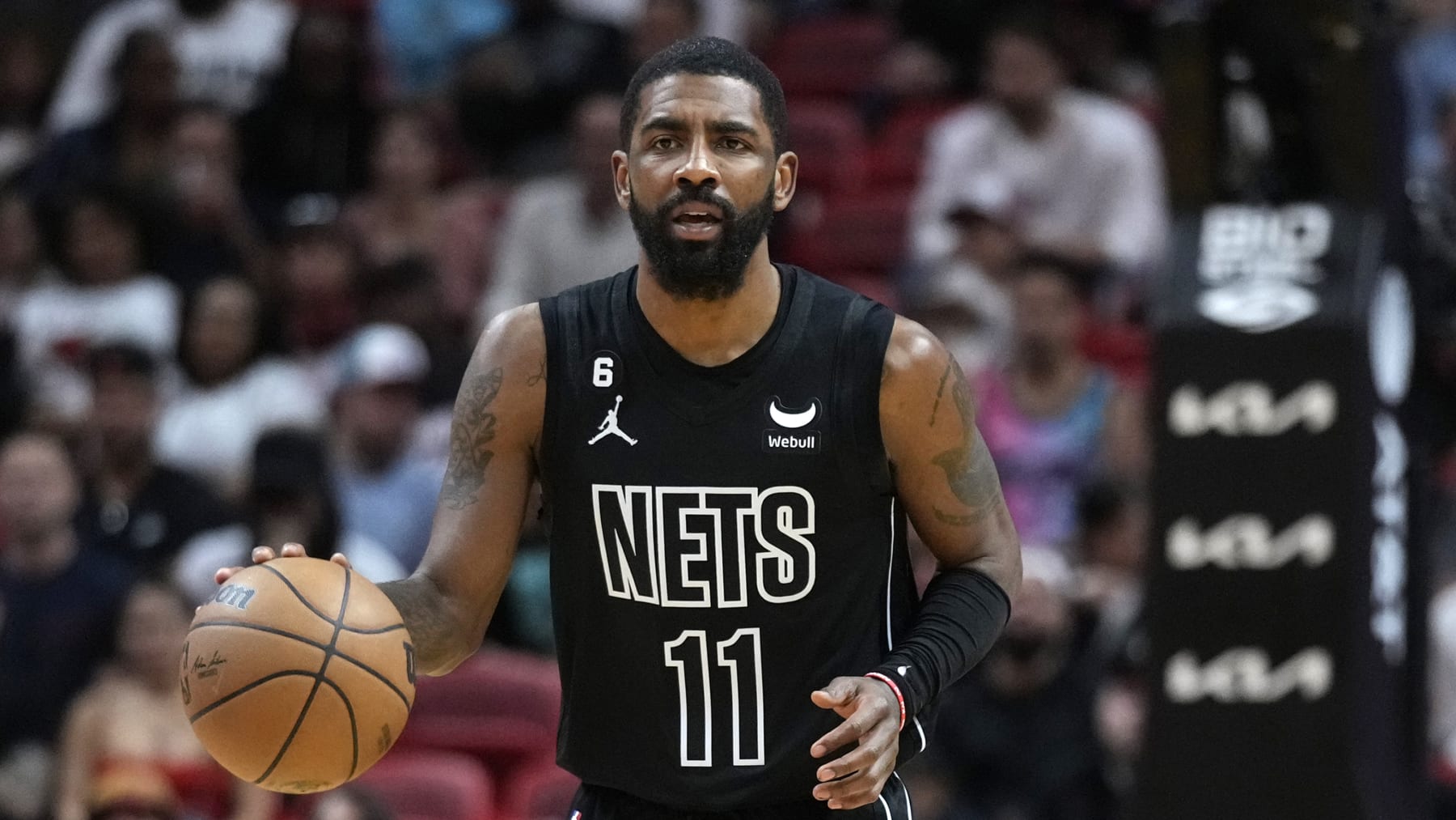 Brooklyn Nets guard Kyrie Irving takes the ball downcourt during the first half of an NBA basketball game against the Miami Heat, Sunday, Jan. 8, 2023, in Miami. (AP Photo/Wilfredo Lee)