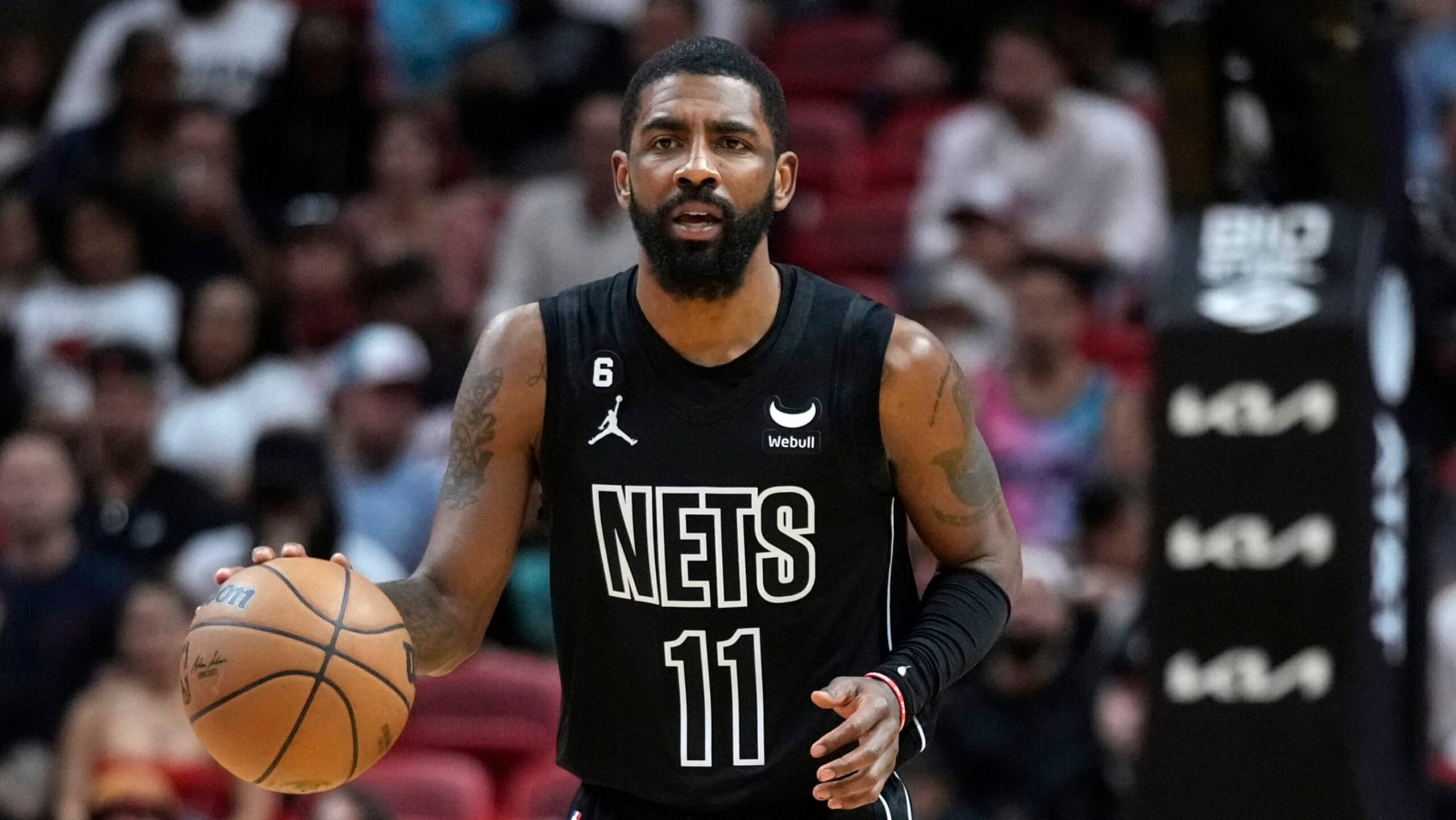 Brooklyn Nets guard Kyrie Irving takes the ball downcourt during the first half of an NBA basketball game against the Miami Heat, Sunday, Jan. 8, 2023, in Miami. (AP Photo/Wilfredo Lee)