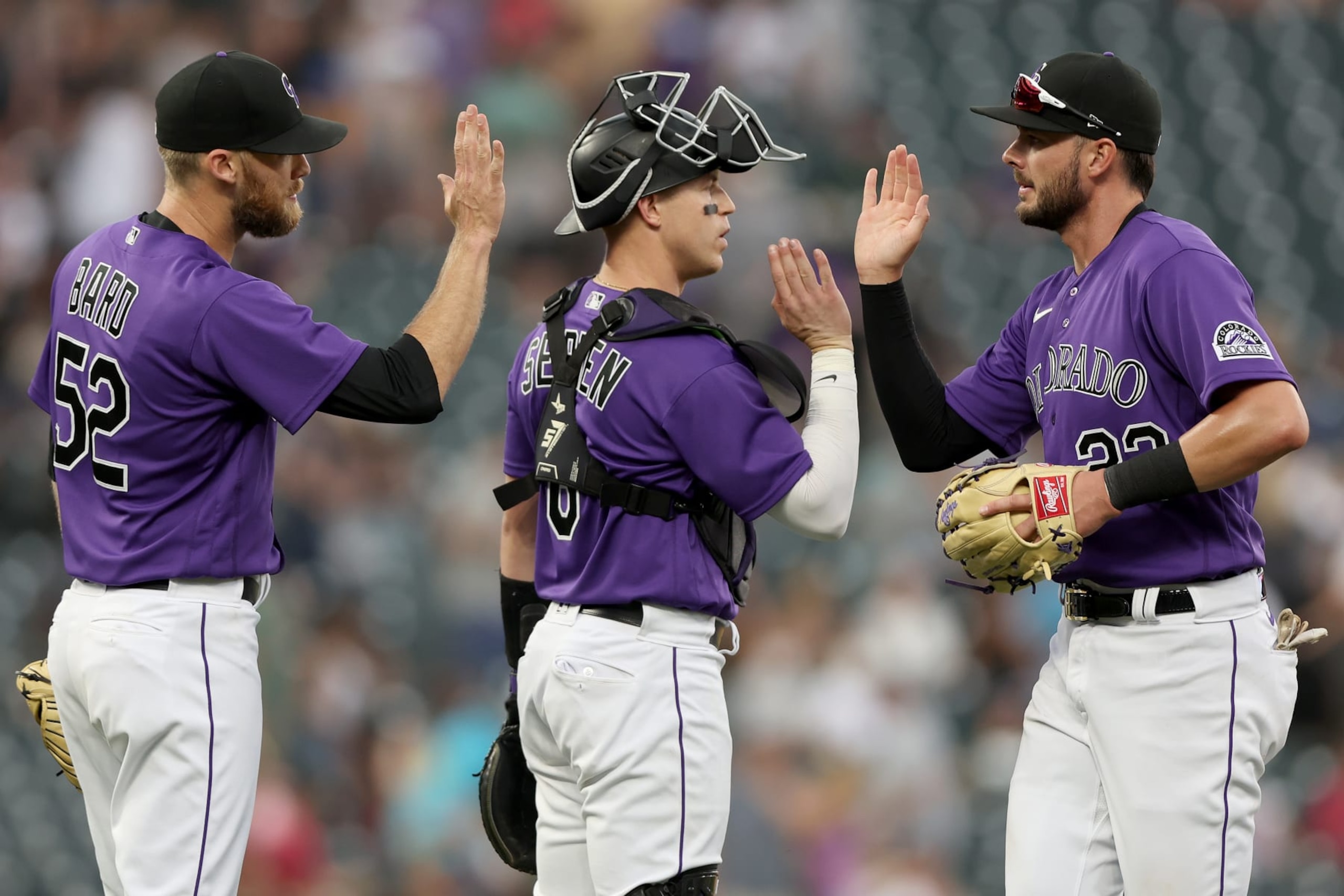 DENVER, COLORADO - JULY 16: Pitcher Jake Bird #59, catcher Brian Serven #6 and Kris Bryant #23 of the Colorado Rockies celebrate their win against the Pittsburgh Pirates at Coors Field on July 16, 2022 in Denver, Colorado. (Photo by Matthew Stockman/Getty Images)