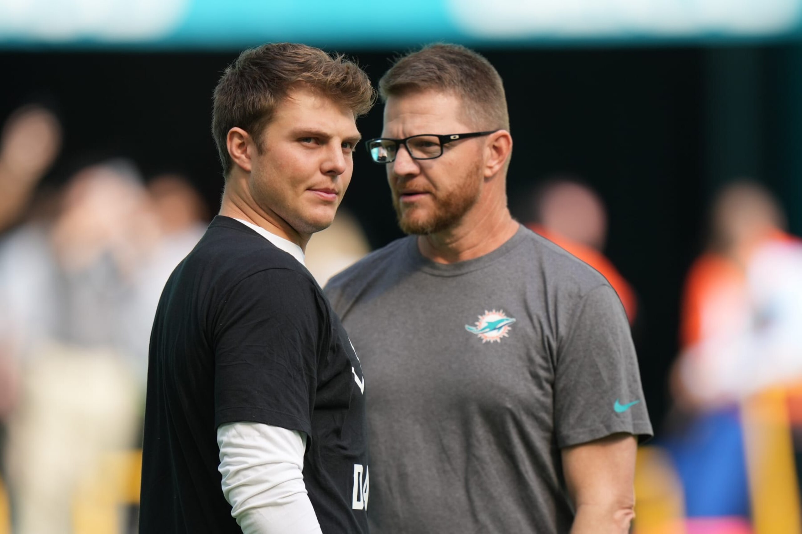 The Jets' Zach Wilson (left) and Dolphins' Darrell Bevell