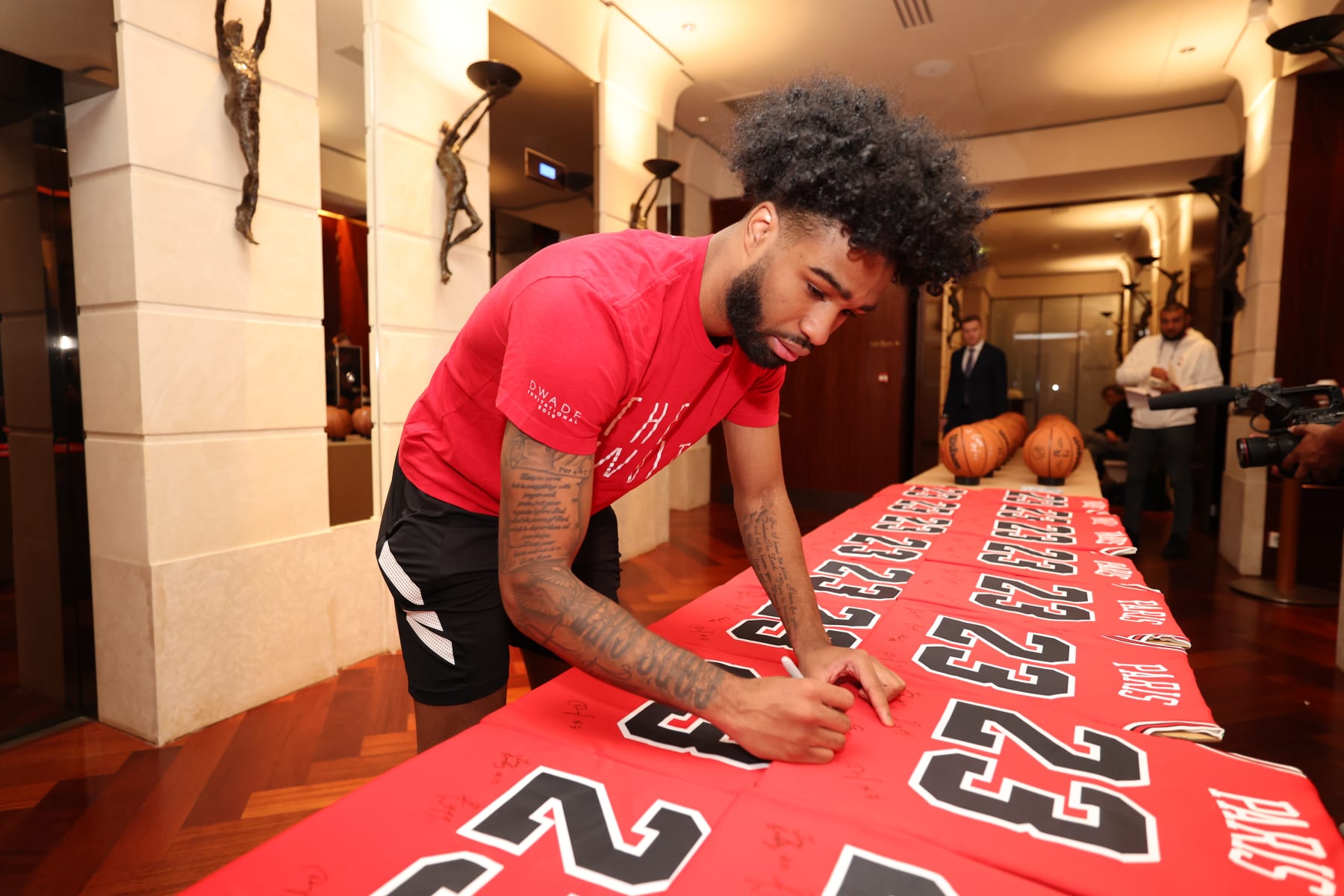 PARIS, FRANCE - JANUARY 18: Coby White #0 of the Chicago Bulls signs basketballs and jerseys at the hotel as part of NBA Paris Games 2023 on January 18, 2023 in Paris, France. NOTE TO USER: User expressly acknowledges and agrees that, by downloading and/or using this Photograph, user is consenting to the terms and conditions of the Getty Images License Agreement. Mandatory Copyright Notice: Copyright 2023 NBAE (Photo by Jeff Haynes/NBAE via Getty Images)