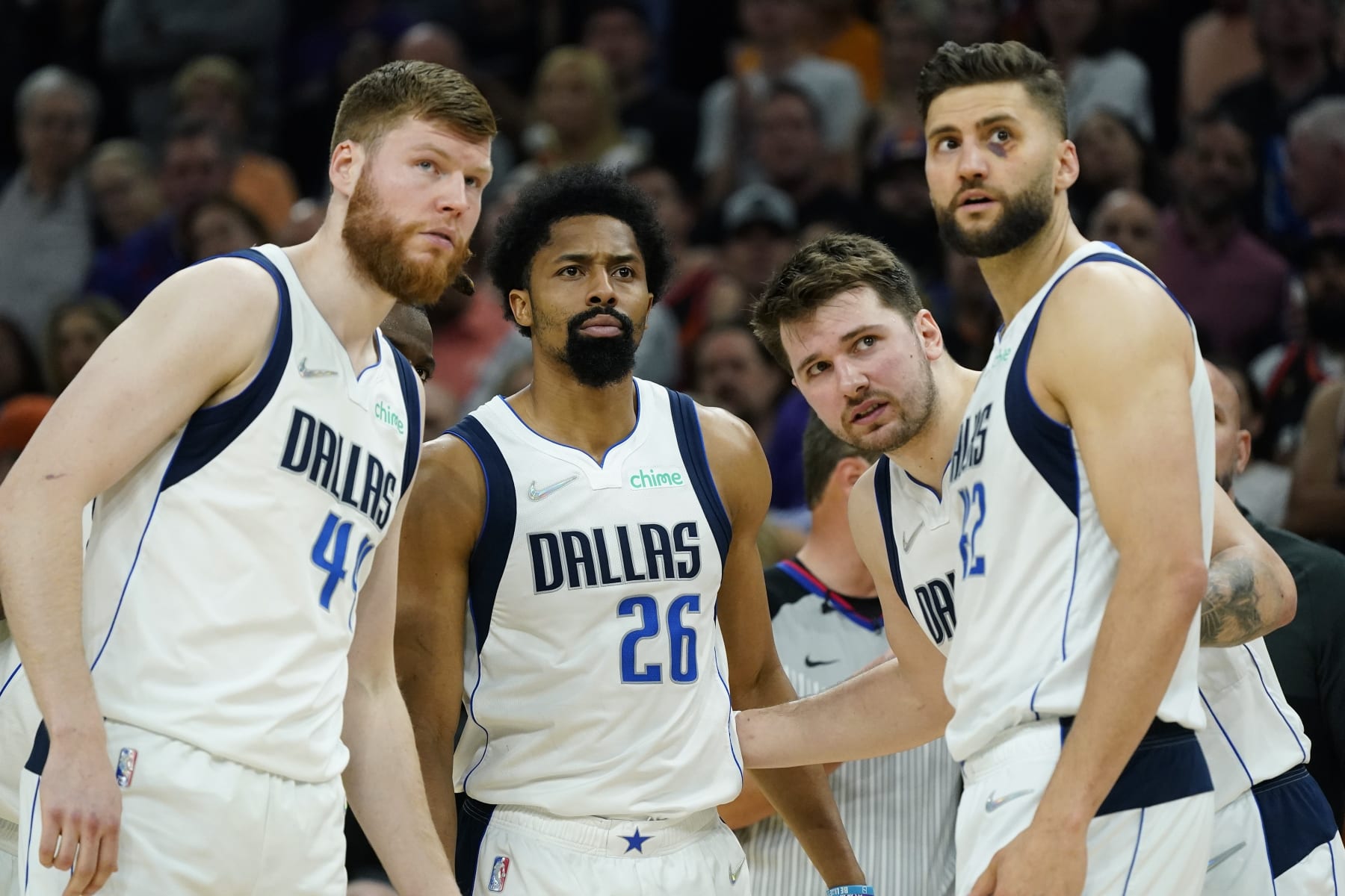 Dallas Mavericks forward Davis Bertans, left, Mavericks guards Spencer Dinwiddie (26), Luka Doncic, second from right, and Mavericks forward Maxi Kleber (42) huddle up during the second half of Game 5 of an NBA basketball second-round playoff series against the Phoenix Suns Tuesday, May 10, 2022, in Phoenix. The Suns won 110-80. (AP Photo/Ross D. Franklin)
