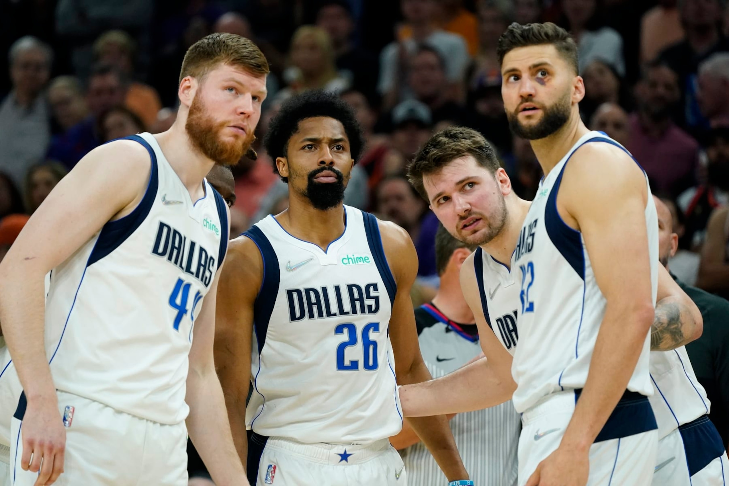Dallas Mavericks forward Davis Bertans, left, Mavericks guards Spencer Dinwiddie (26), Luka Doncic, second from right, and Mavericks forward Maxi Kleber (42) huddle up during the second half of Game 5 of an NBA basketball second-round playoff series against the Phoenix Suns Tuesday, May 10, 2022, in Phoenix. The Suns won 110-80. (AP Photo/Ross D. Franklin)