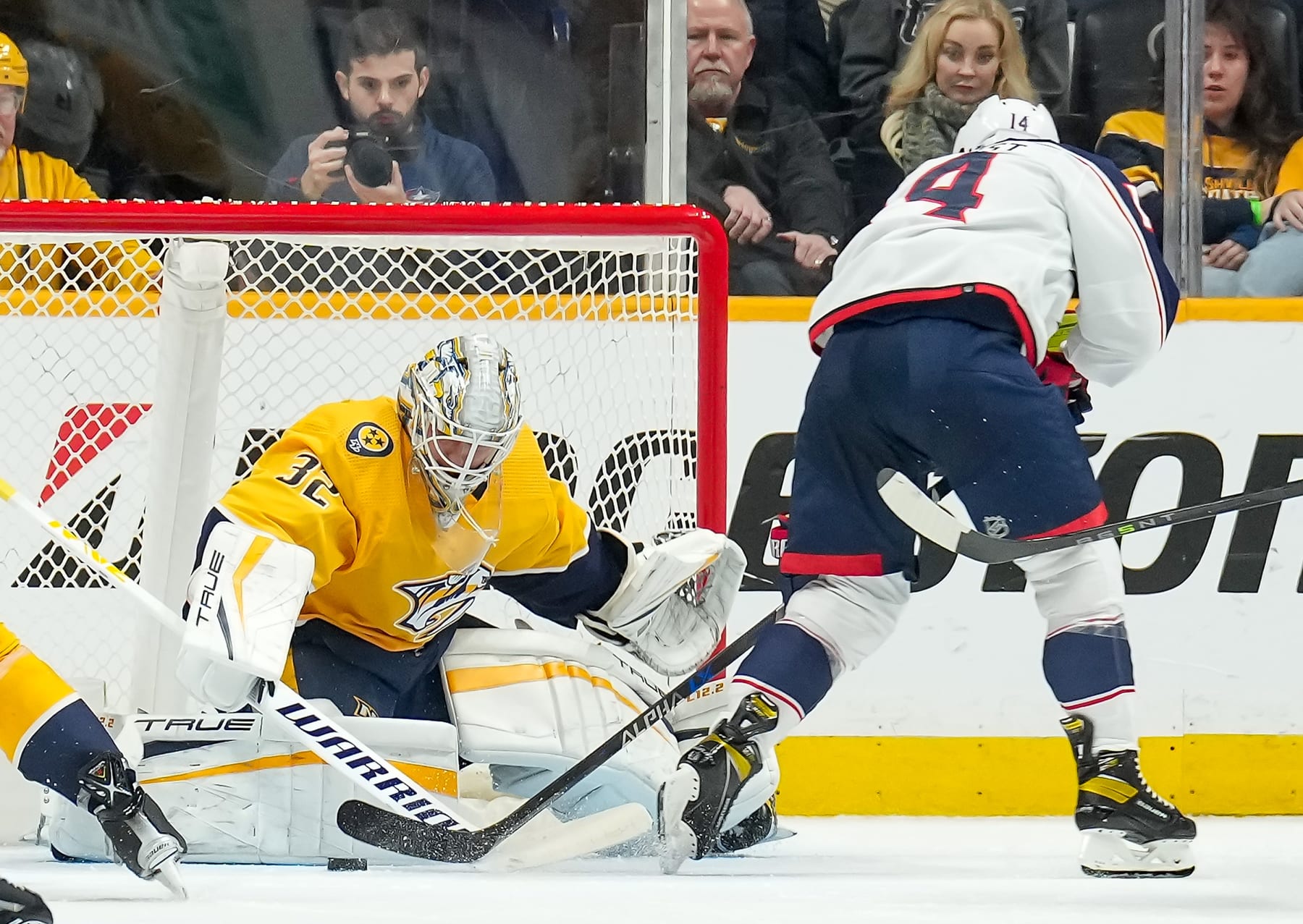 NASHVILLE, TENNESSEE - JANUARY 17: Kevin Lankinen #32 of the Nashville Predators makes the save against Gustav Nyquist #14 of the Columbus Blue Jackets during an NHL game at Bridgestone Arena on January 17, 2023 in Nashville, Tennessee. (Photo by John Russell/NHLI via Getty Images)