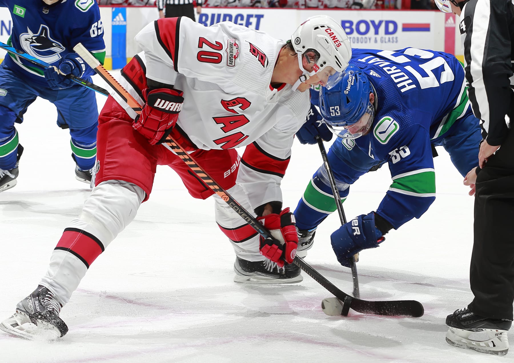 VANCOUVER, CANADA - OCTOBER 24: Bo Horvat #53 of the Vancouver Canucks faces off against Sebastian Aho #20 of the Carolina Hurricanes during their NHL game at Rogers Arena October 24, 2022 in Vancouver, British Columbia, Canada.  (Photo by Jeff Vinnick/NHLI via Getty Images)