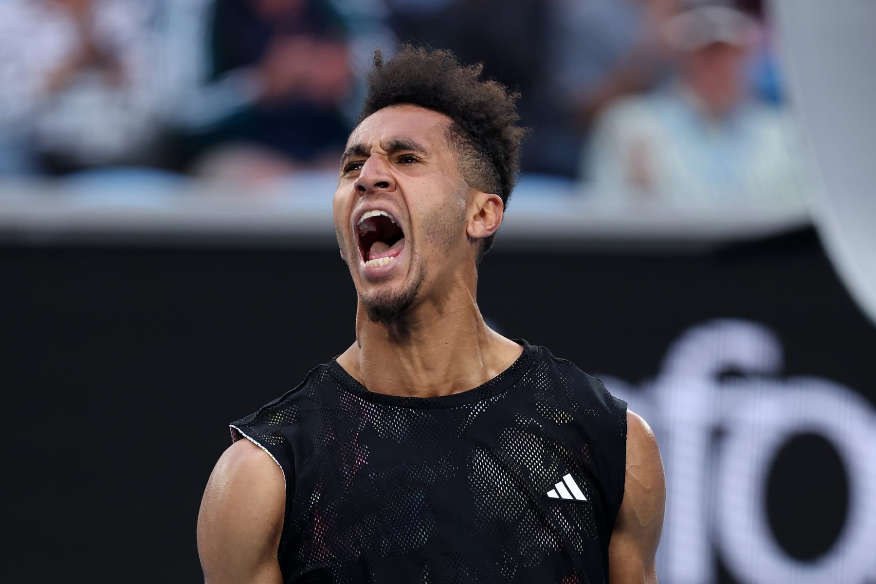 MELBOURNE, AUSTRALIA - JANUARY 19: Michael Mmoh of the United States celebrates match point in their round two singles match against Alexander Zverev of Germany during day four of the 2023 Australian Open at Melbourne Park on January 19, 2023 in Melbourne, Australia. (Photo by Clive Brunskill/Getty Images)
