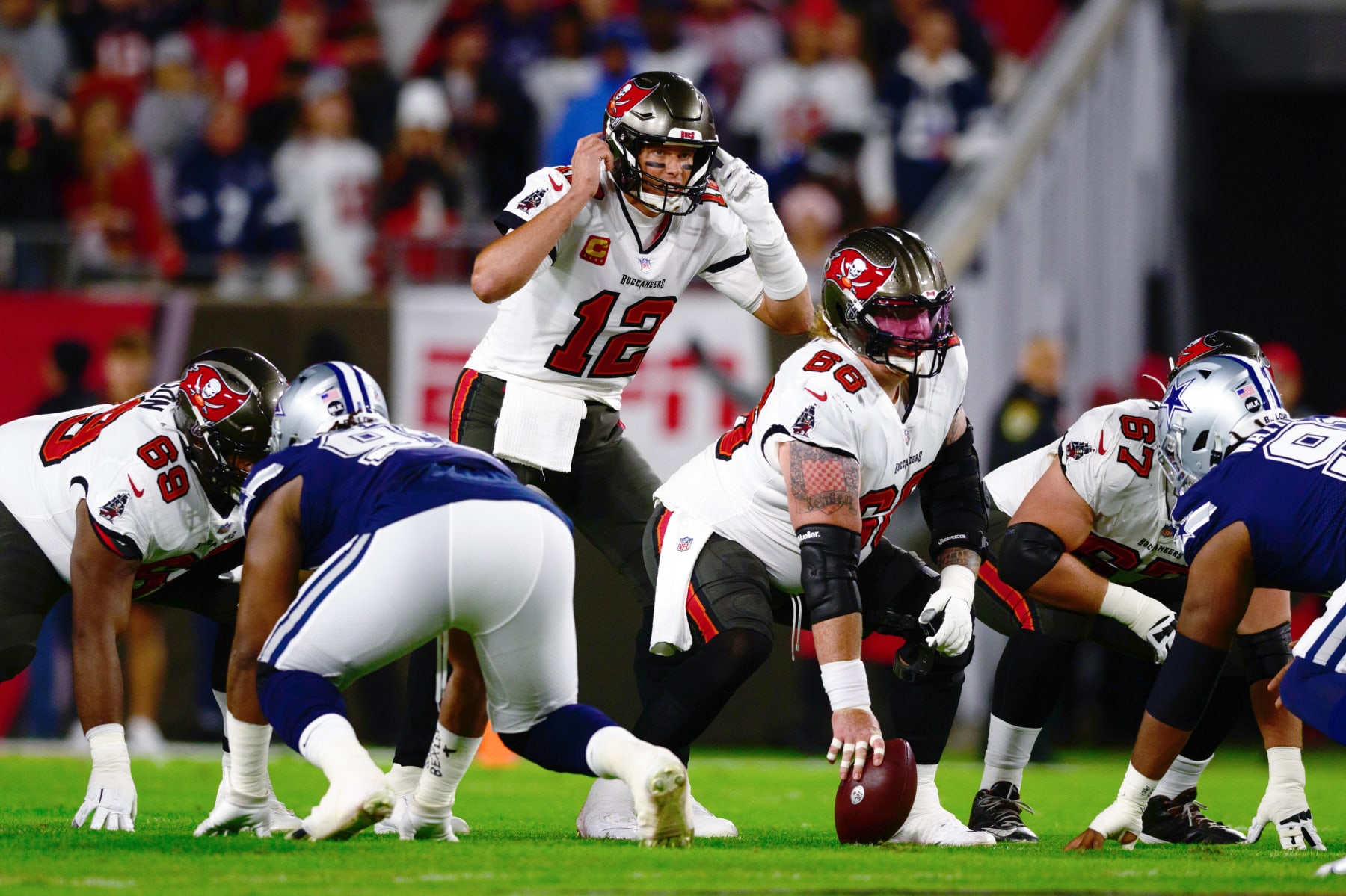 TAMPA, FLORIDA - JANUARY 16: Tom Brady #12 of the Tampa Bay Buccaneers looks on at the line of scrimmage against the Dallas Cowboys during the first half in the NFC Wild Card playoff game at Raymond James Stadium on January 16, 2023 in Tampa, Florida. (Photo by Julio Aguilar/Getty Images)