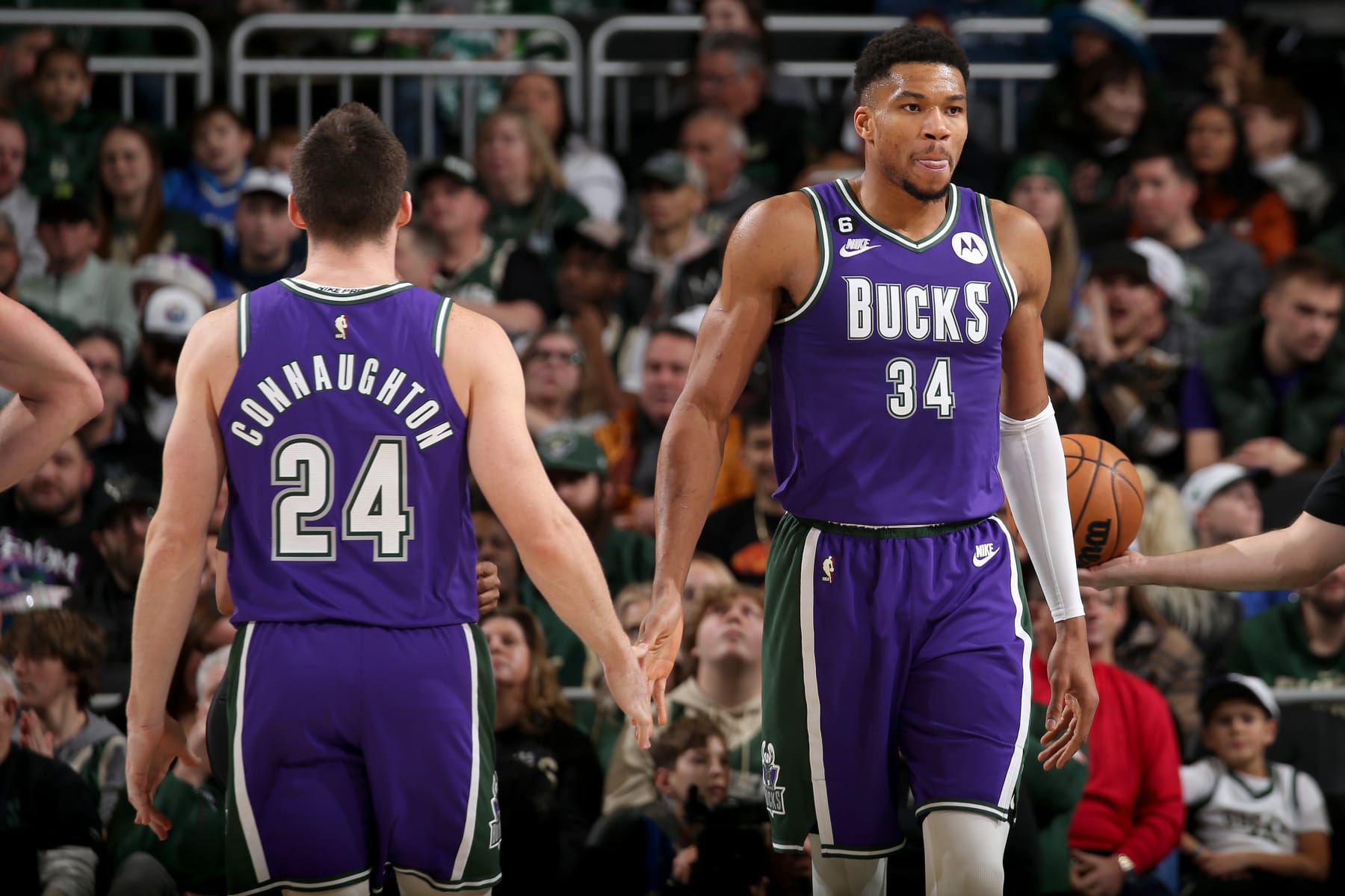 MILWAUKEE, WI - JANUARY 6: Pat Connaughton #24 and Giannis Antetokounmpo #34 of the Milwaukee Bucks high fives during the game against the Charlotte Hornets on January 6, 2023 at the Fiserv Forum Center in Milwaukee, Wisconsin. NOTE TO USER: User expressly acknowledges and agrees that, by downloading and or using this Photograph, user is consenting to the terms and conditions of the Getty Images License Agreement. Mandatory Copyright Notice: Copyright 2022 NBAE (Photo by Gary Dineen/NBAE via Getty Images).