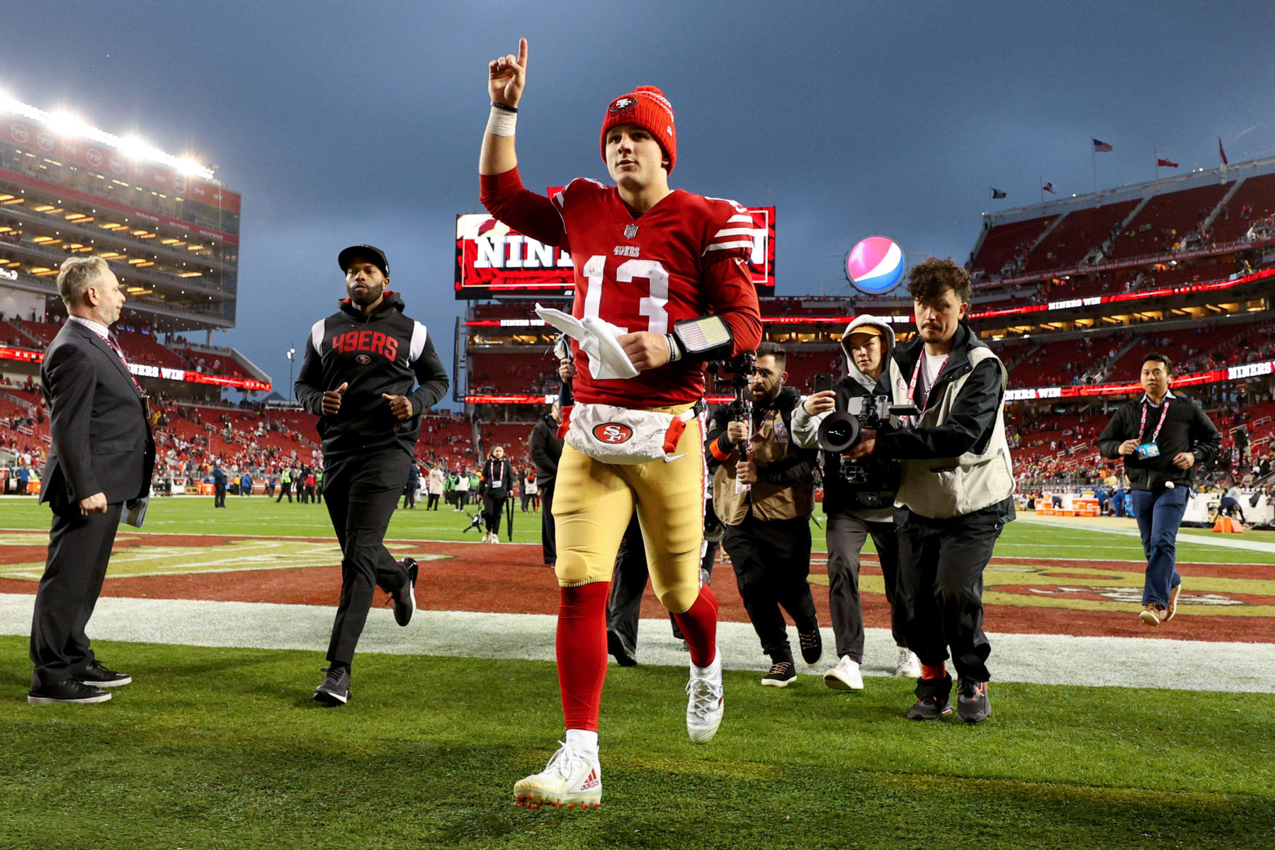 SANTA CLARA, CALIFORNIA - JANUARY 14: Brock Purdy #13 of the San Francisco 49ers runs off the field after defeating the Seattle Seahawks in the NFC Wild Card playoff game at Levi's Stadium on January 14, 2023 in Santa Clara, California. (Photo by Ezra Shaw/Getty Images)