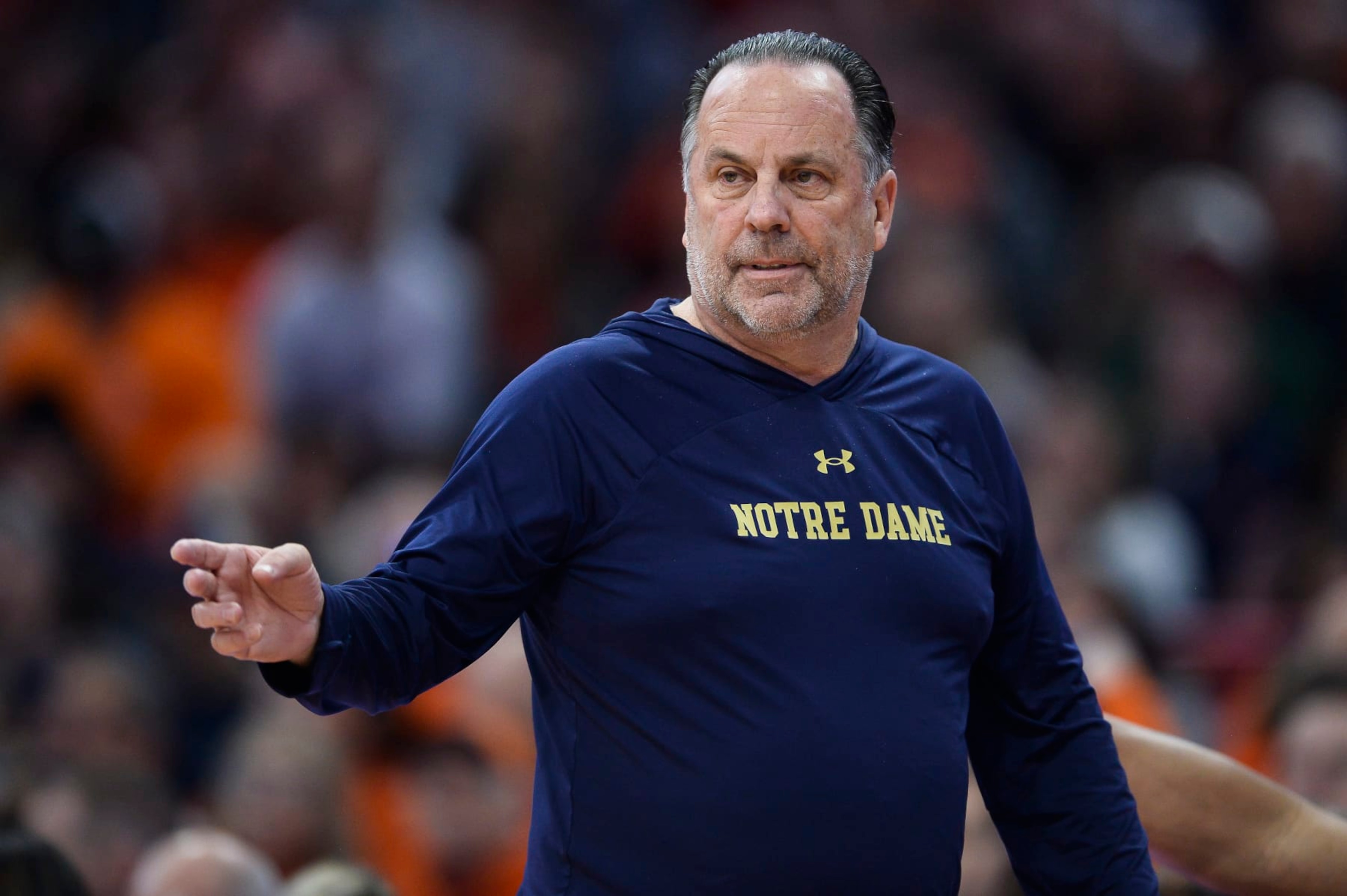 Notre Dame head coach Mike Brey directs players during the first half of the team's NCAA college basketball game against Syracuse in Syracuse, N.Y., Saturday, Jan. 14, 2023. (AP Photo/Adrian Kraus)