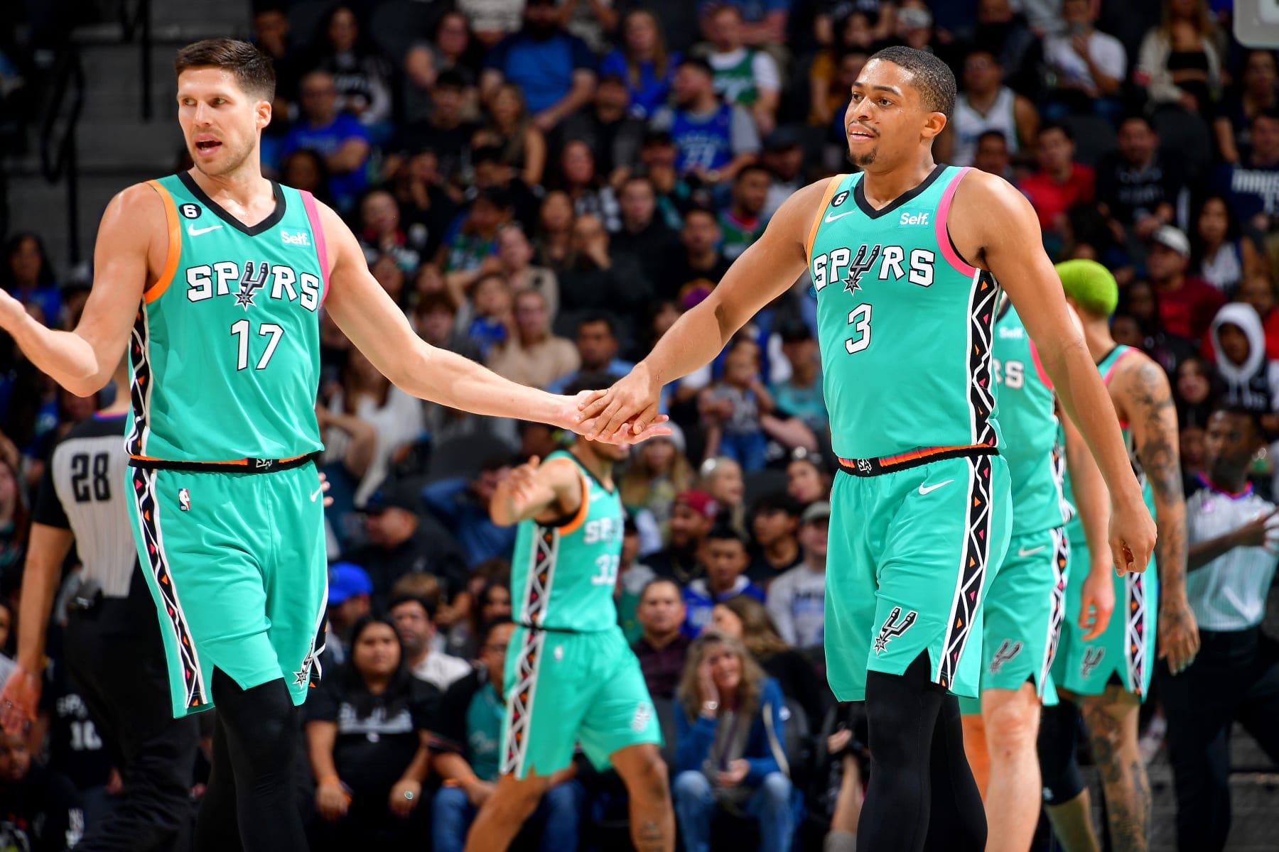 SAN ANTONIO, TX - DECEMBER 31: Doug McDermott #17 and Keldon Johnson #3 of the San Antonio Spurs high fives during the game against the Dallas Mavericks on December 31, 2022 at the AT&T Center in San Antonio, Texas. NOTE TO USER: User expressly acknowledges and agrees that, by downloading and or using this photograph, user is consenting to the terms and conditions of the Getty Images License Agreement. Mandatory Copyright Notice: Copyright 2022 NBAE (Photos by Michael Gonzales/NBAE via Getty Images)