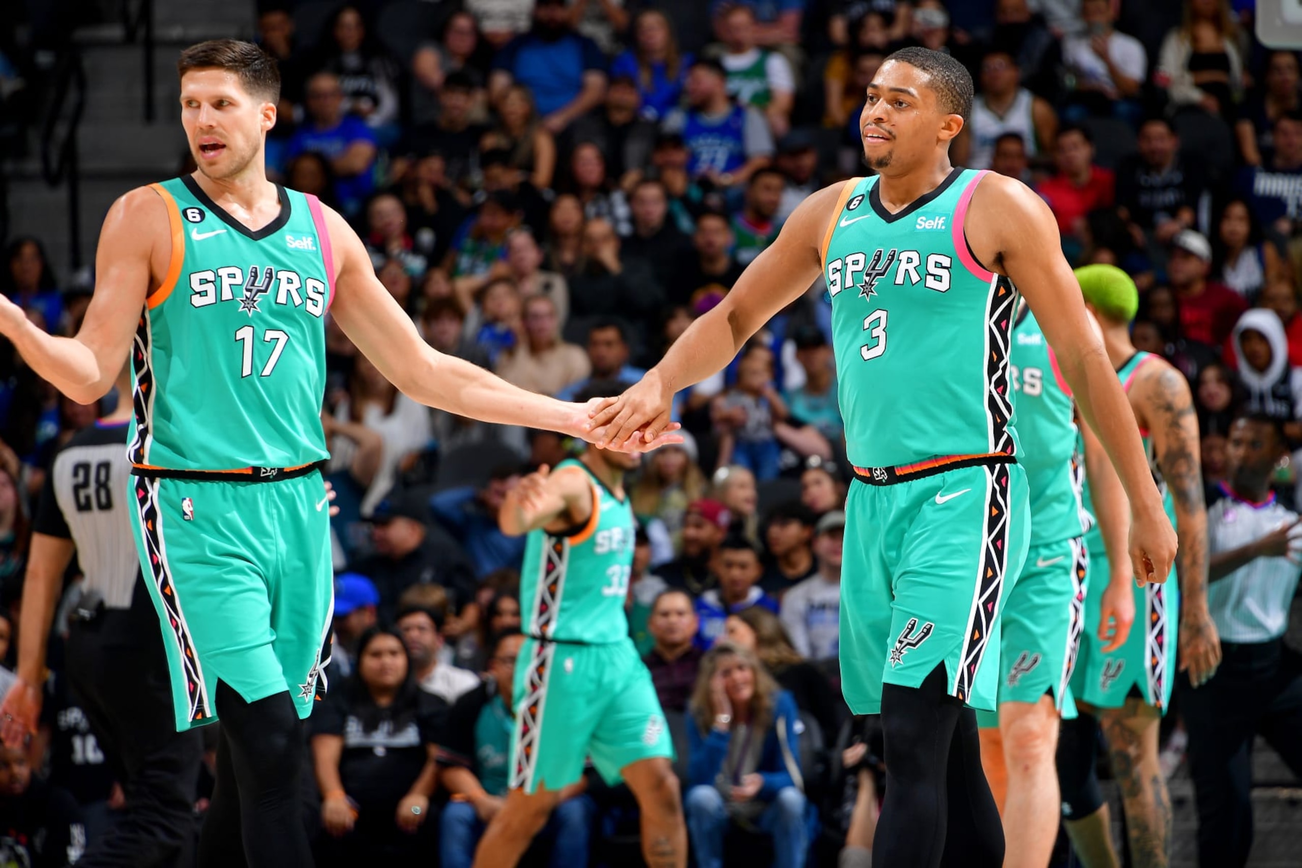 SAN ANTONIO, TX - DECEMBER 31: Doug McDermott #17 and Keldon Johnson #3 of the San Antonio Spurs high fives during the game against the Dallas Mavericks on December 31, 2022 at the AT&T Center in San Antonio, Texas. NOTE TO USER: User expressly acknowledges and agrees that, by downloading and or using this photograph, user is consenting to the terms and conditions of the Getty Images License Agreement. Mandatory Copyright Notice: Copyright 2022 NBAE (Photos by Michael Gonzales/NBAE via Getty Images)
