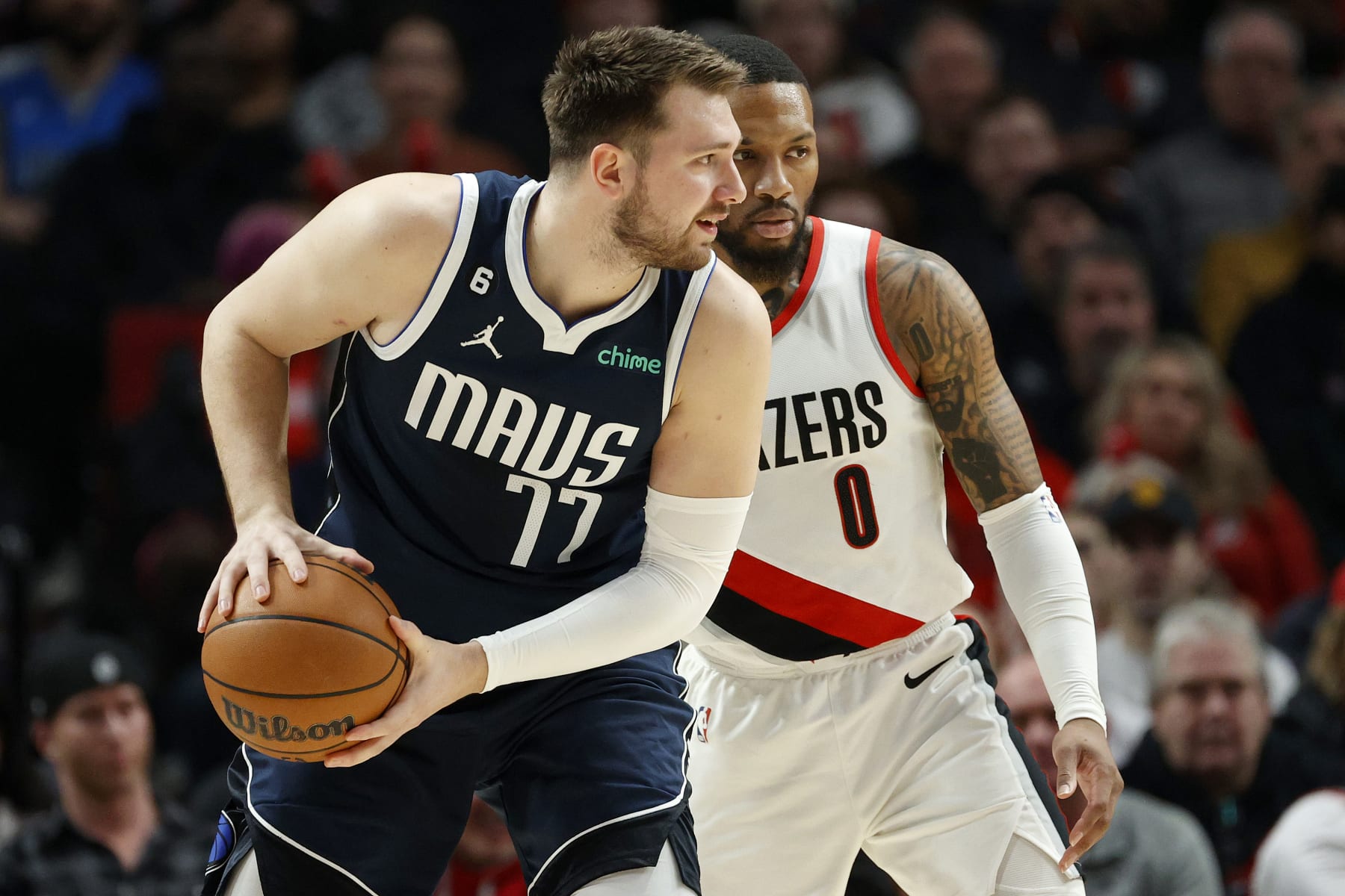 PORTLAND, OREGON - JANUARY 14: Damian Lillard #0 of the Portland Trail Blazers guards Luka Doncic #77 of the Dallas Mavericks during the first quarter at Moda Center on January 14, 2023 in Portland, Oregon. NOTE TO USER: User expressly acknowledges and agrees that, by downloading and or using this photograph, user is consenting to the terms and conditions of the Getty Images License Agreement. (Photo by Steph Chambers/Getty Images)