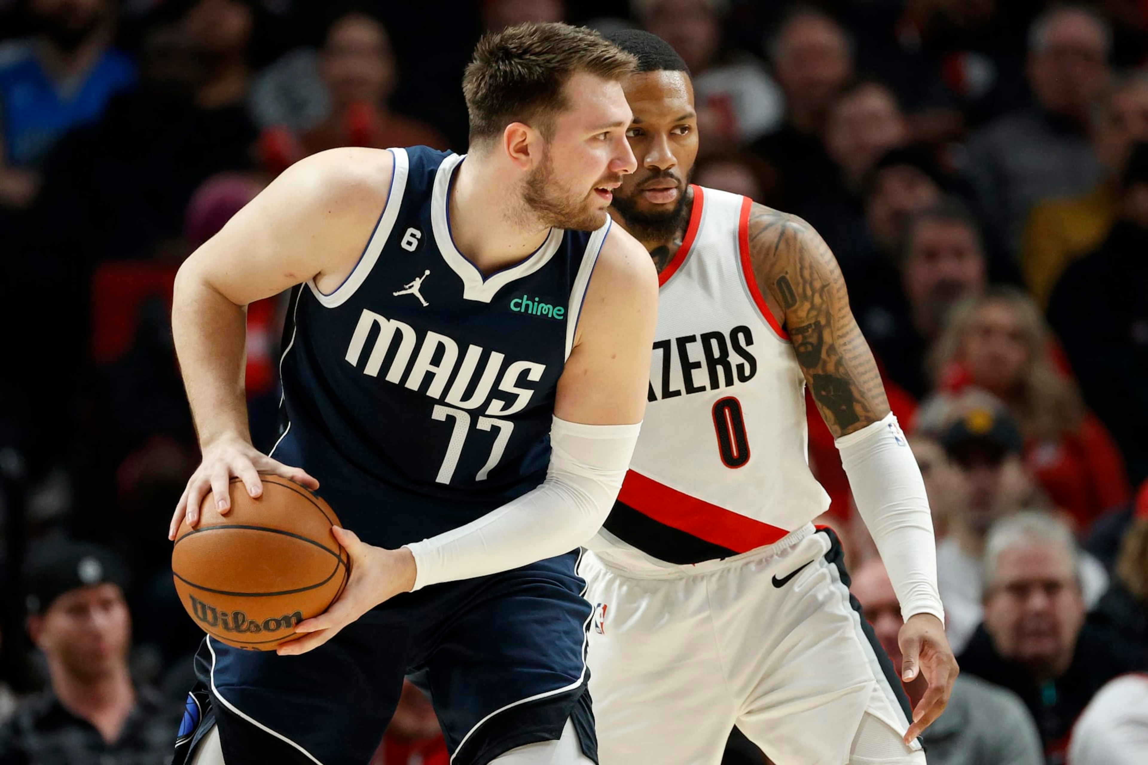 PORTLAND, OREGON - JANUARY 14: Damian Lillard #0 of the Portland Trail Blazers guards Luka Doncic #77 of the Dallas Mavericks during the first quarter at Moda Center on January 14, 2023 in Portland, Oregon. NOTE TO USER: User expressly acknowledges and agrees that, by downloading and or using this photograph, user is consenting to the terms and conditions of the Getty Images License Agreement. (Photo by Steph Chambers/Getty Images) PORTLAND, OREGON - JANUARY 14: Damian Lillard #0 of the Portland Trail Blazers guards Luka Doncic #77 of the Dallas Mavericks during the first quarter at Moda Center on January 14, 2023 in Portland, Oregon. NOTE TO USER: User expressly acknowledges and agrees that, by downloading and or using this photograph, user is consenting to the terms and conditions of the Getty Images License Agreement. (Photo by Steph Chambers/Getty Images)