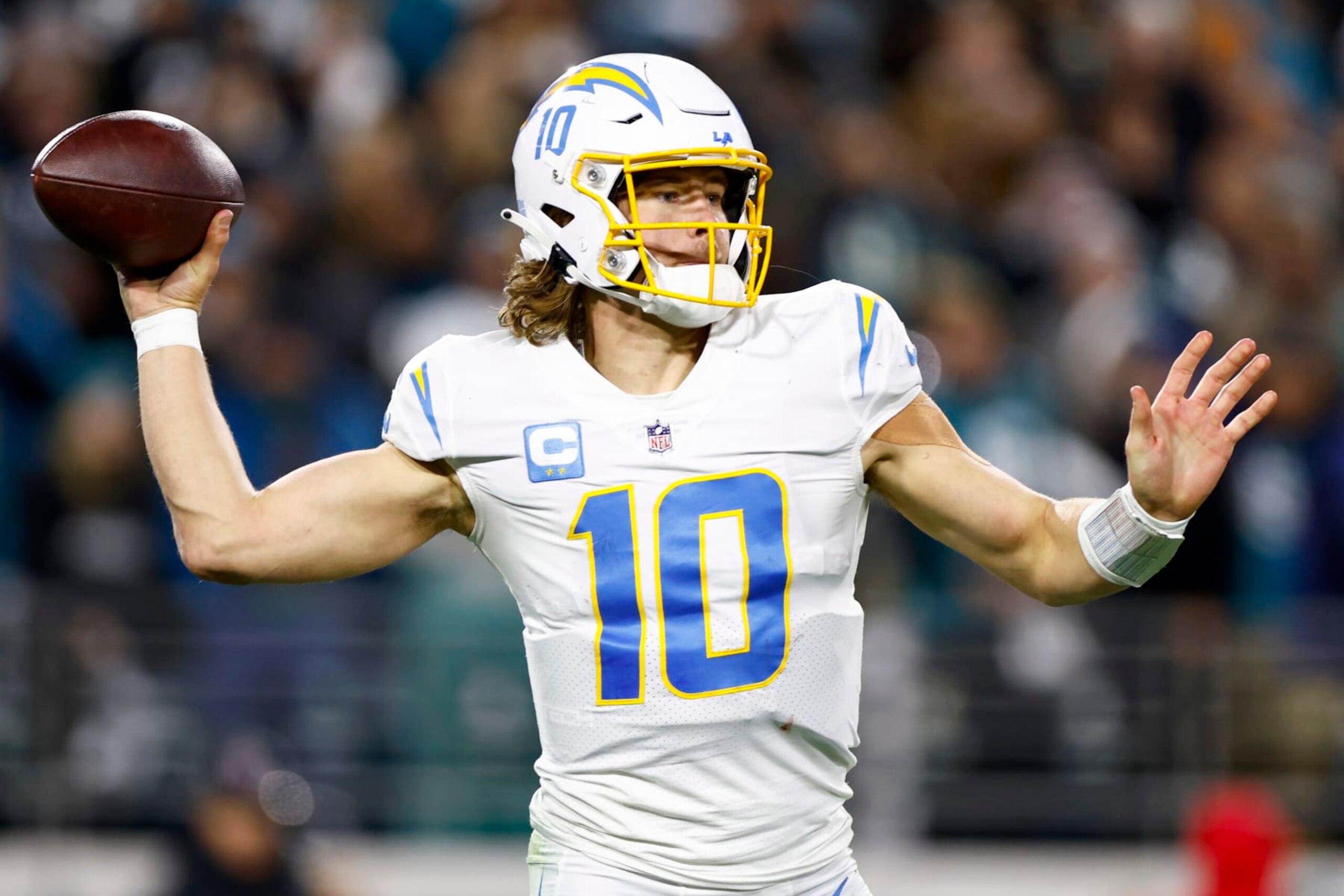 JACKSONVILLE, FLORIDA - JANUARY 14: Justin Herbert #10 of the Los Angeles Chargers throws a pass against the Jacksonville Jaguars during the second half of the game in the AFC Wild Card playoff game at TIAA Bank Field on January 14, 2023 in Jacksonville, Florida. (Photo by Douglas P. DeFelice/Getty Images)