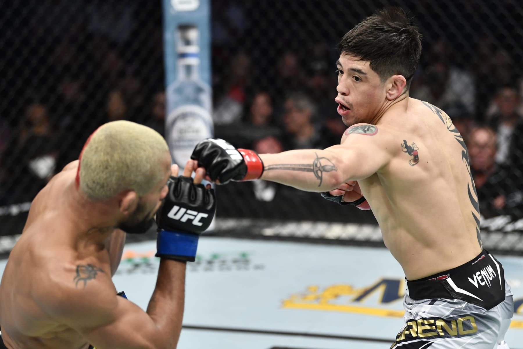 ANAHEIM, CALIFORNIA - JANUARY 22: (R-L) Brandon Moreno of Mexico punches Deiveson Figueiredo of Brazil in their UFC flyweight championship fight during the UFC 270 event at Honda Center on January 22, 2022 in Anaheim, California. (Photo by Chris Unger/Zuffa LLC)