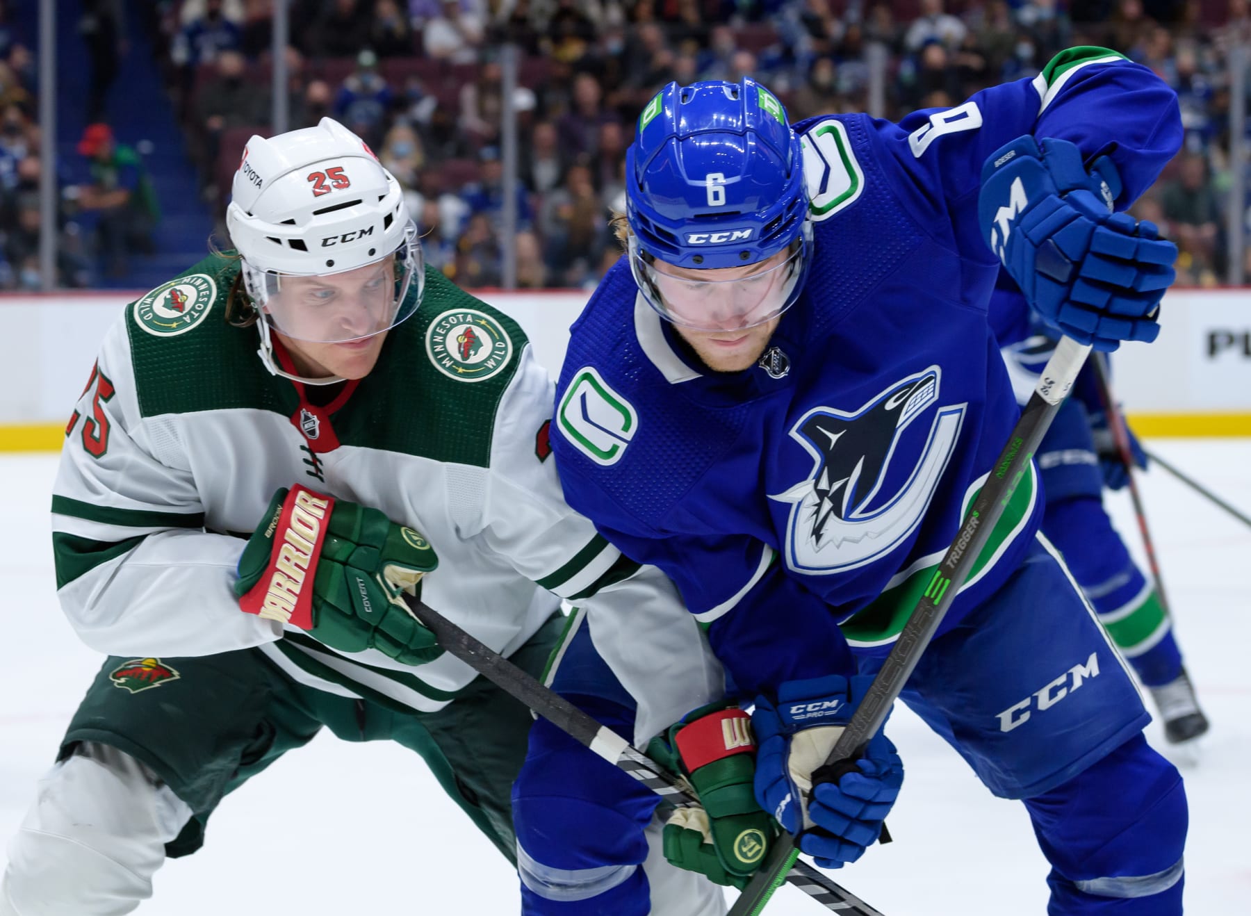 VANCOUVER, BC - OCTOBER 26:  Vancouver Canucks right wing Brock Boeser (6) and Minnesota Wild defenseman Jonas Brodin (25) battle for the puck during their NHL game at Rogers Arena on October 26, 2021 in Vancouver, British Columbia, Canada. (Photo by Derek Cain/Icon Sportswire via Getty Images)